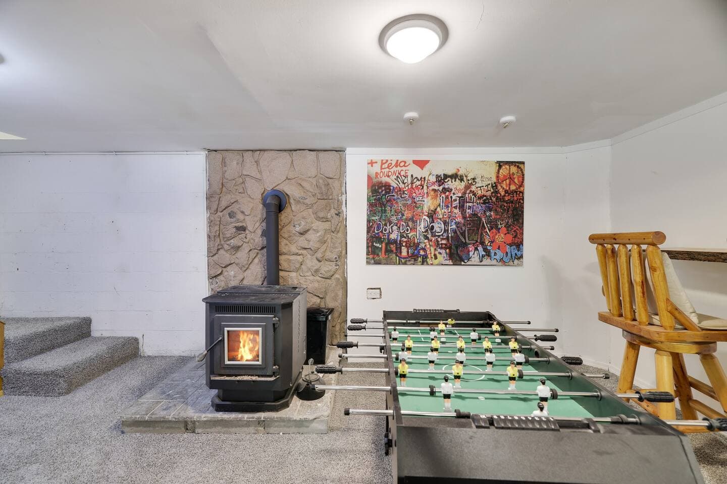 Lower level with pellet fireplace and foosball