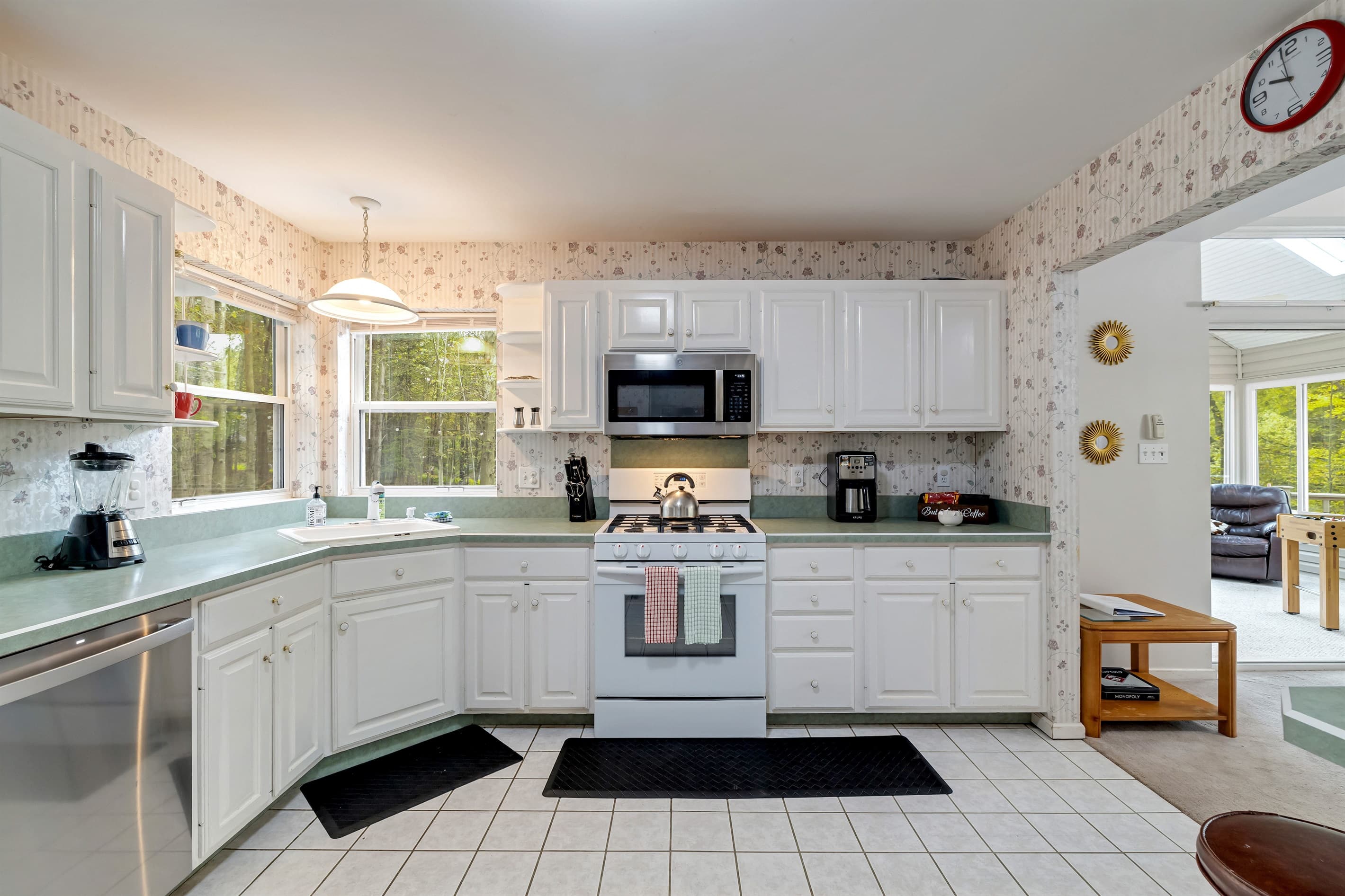Fully stocked kitchen with lots of space: dishwasher, fridge, blender, microwave, toaster
