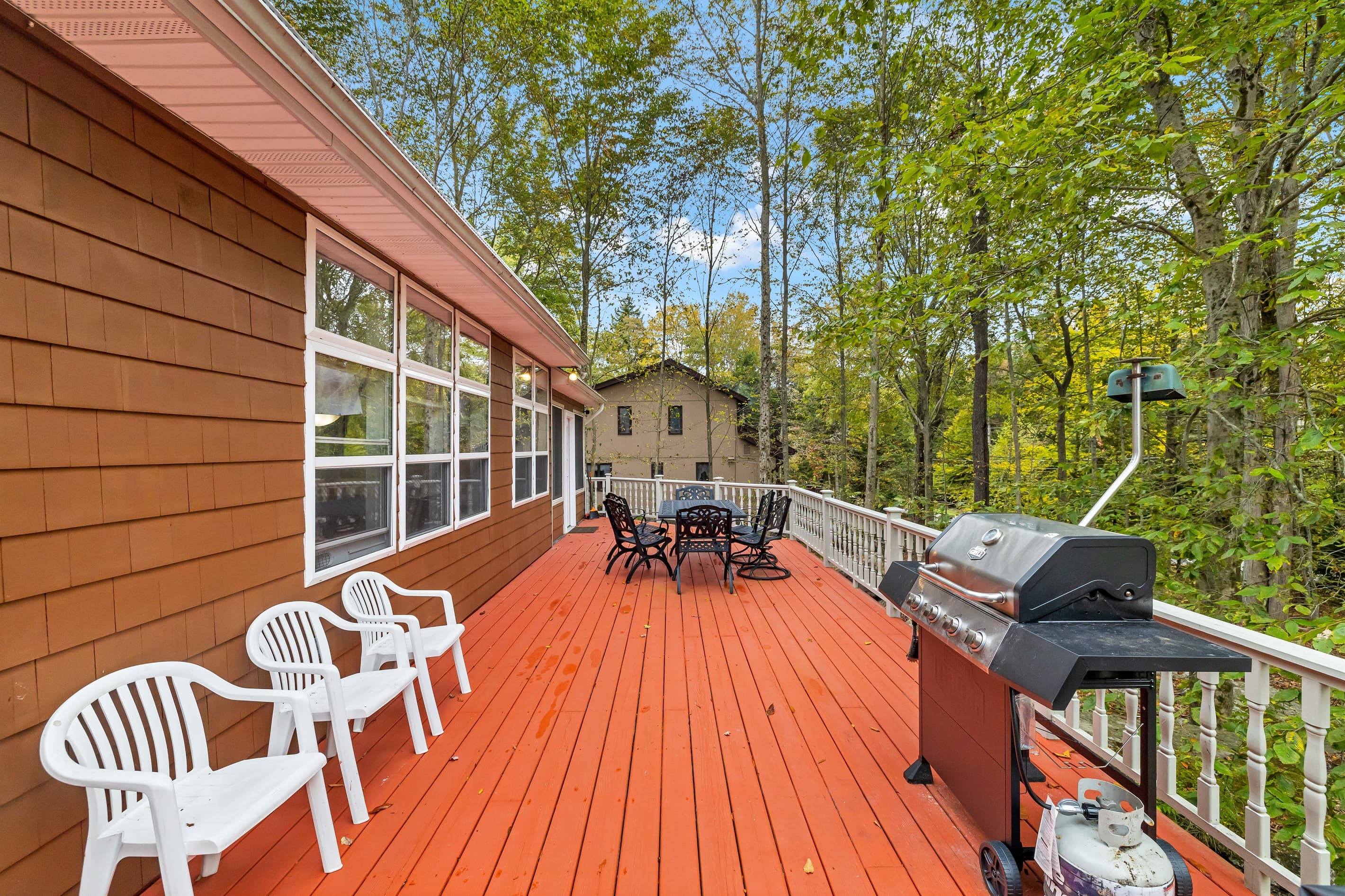 Large deck with outdoor dining and BBQ grill