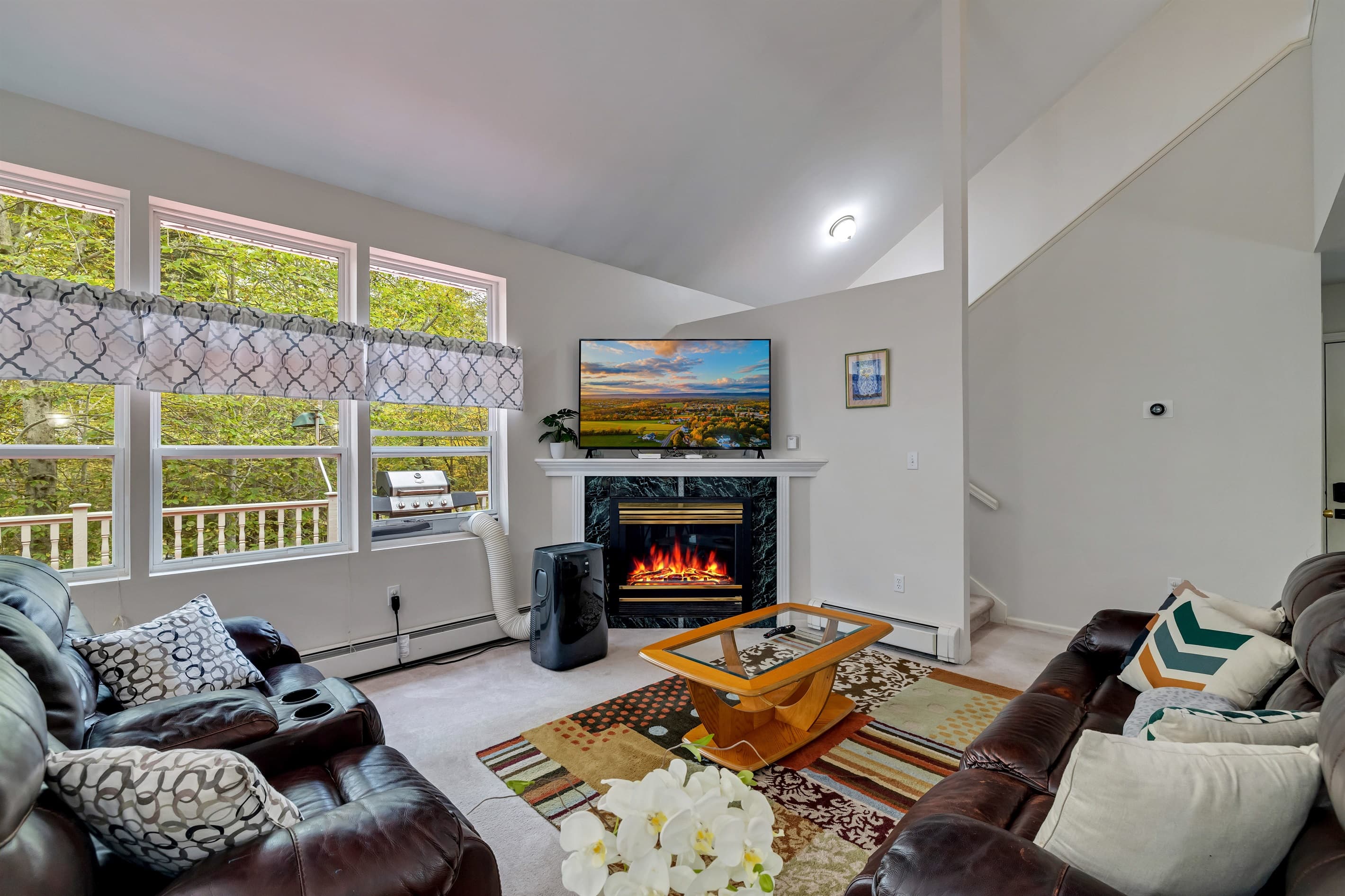 Living room with smart TV and comfortable seating