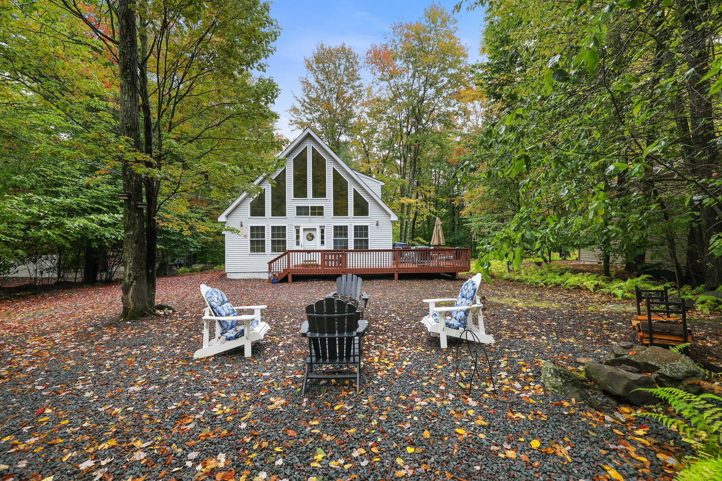 Pocono rentals - view in fall, large deck with table and seating, BBQ
