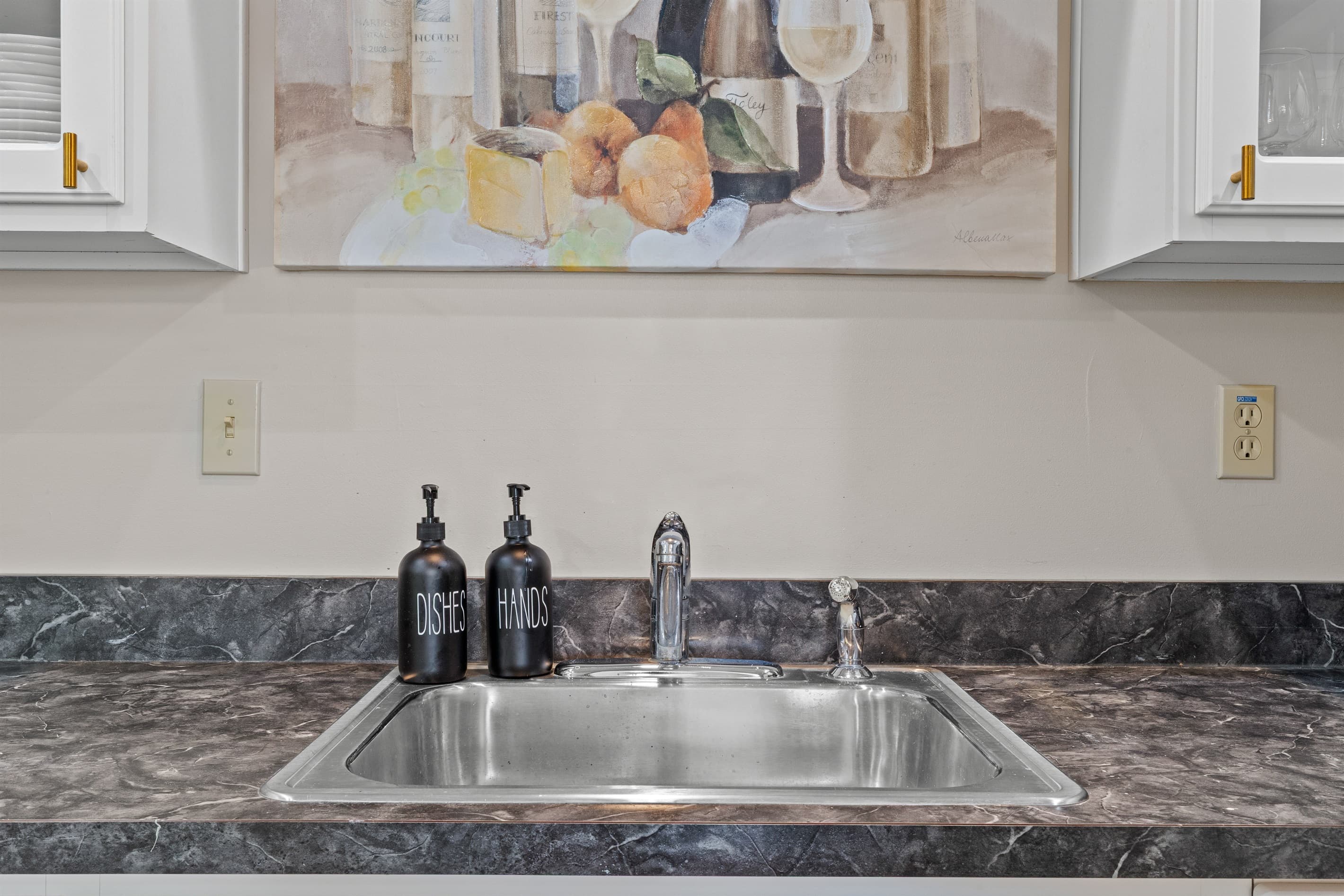 Fully stocked kitchen with white appliances, stainless sink, dishwasher, microwave, toaster, and coffee maker.