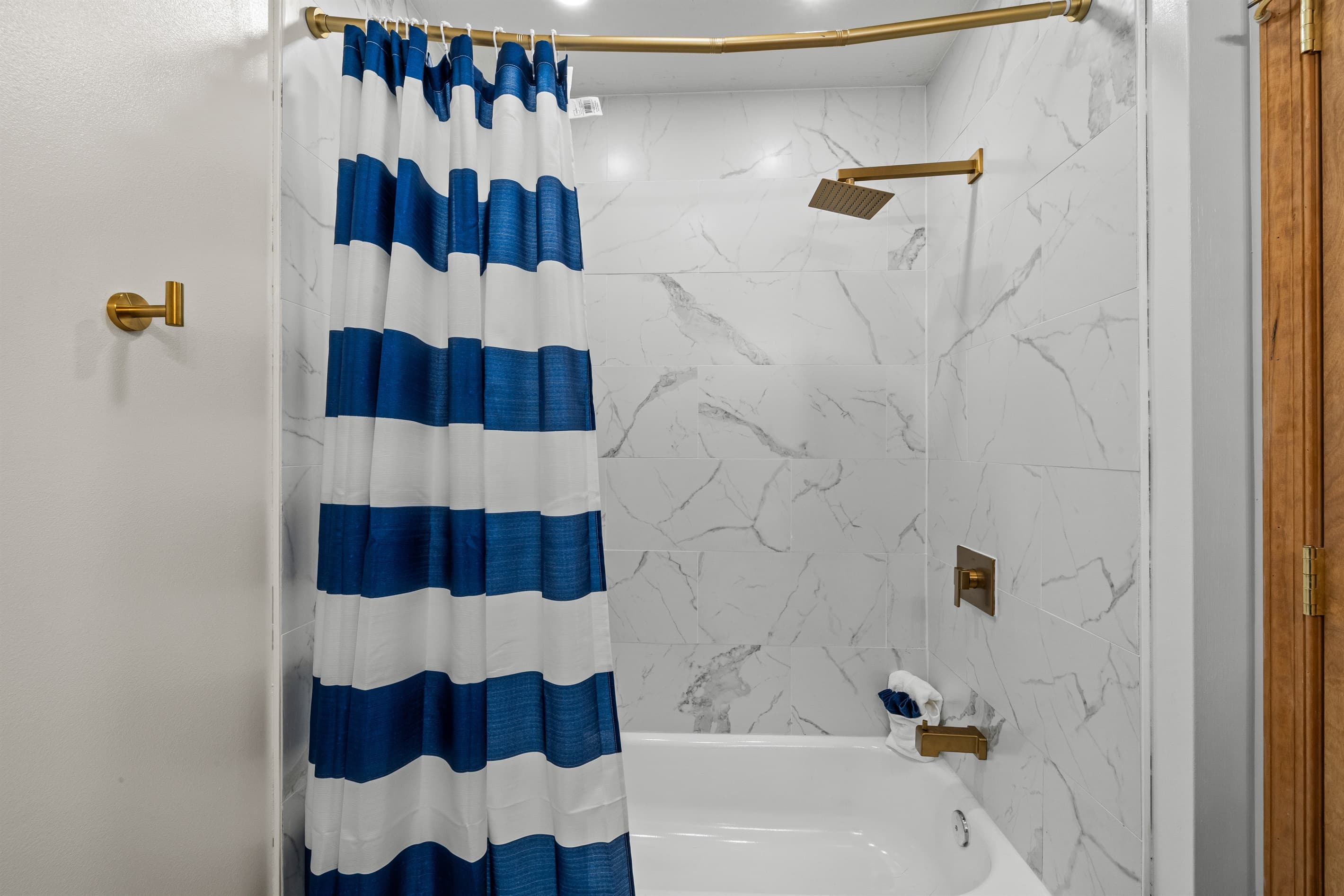 Full bathroom with a bathtub and toilet, ideal for family use.