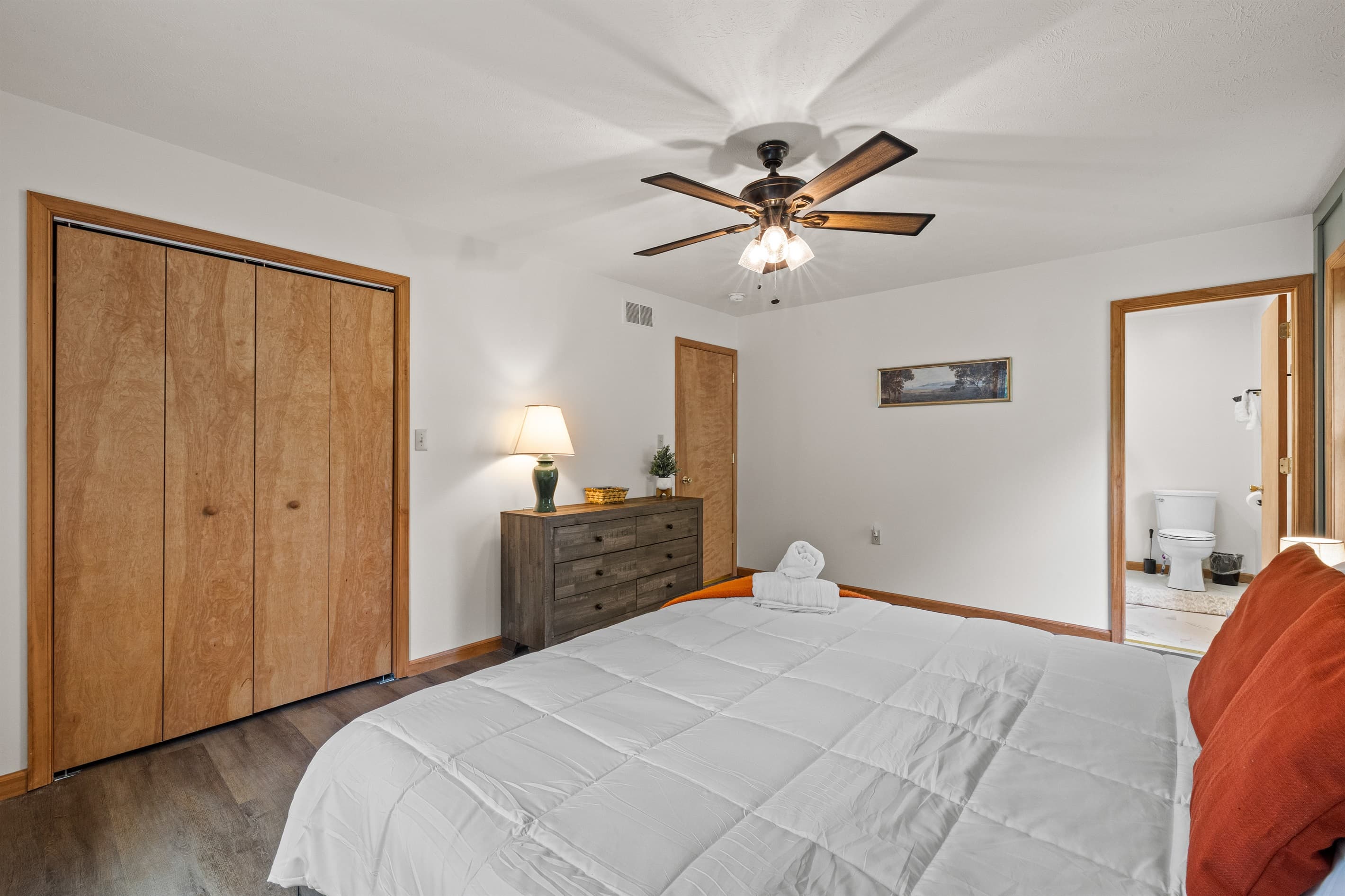 Primary bedroom with a king-size bed and private ensuite bathroom for added comfort.