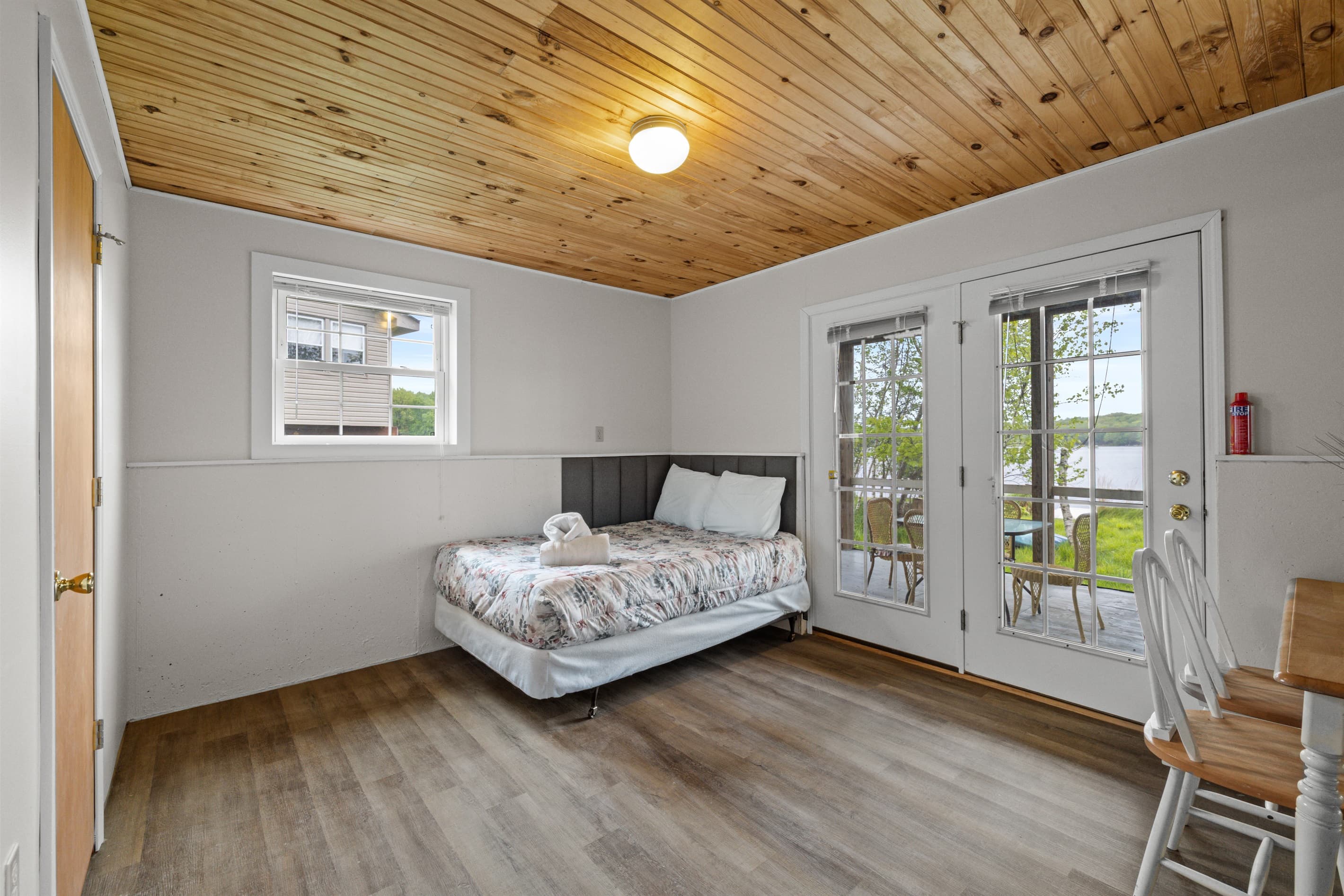 Bonus room offers extra space to spread out, featuring a full-size bed, a cozy TV sofa, and a small dining table—perfect for games, casual meals, or relaxing with a movie.