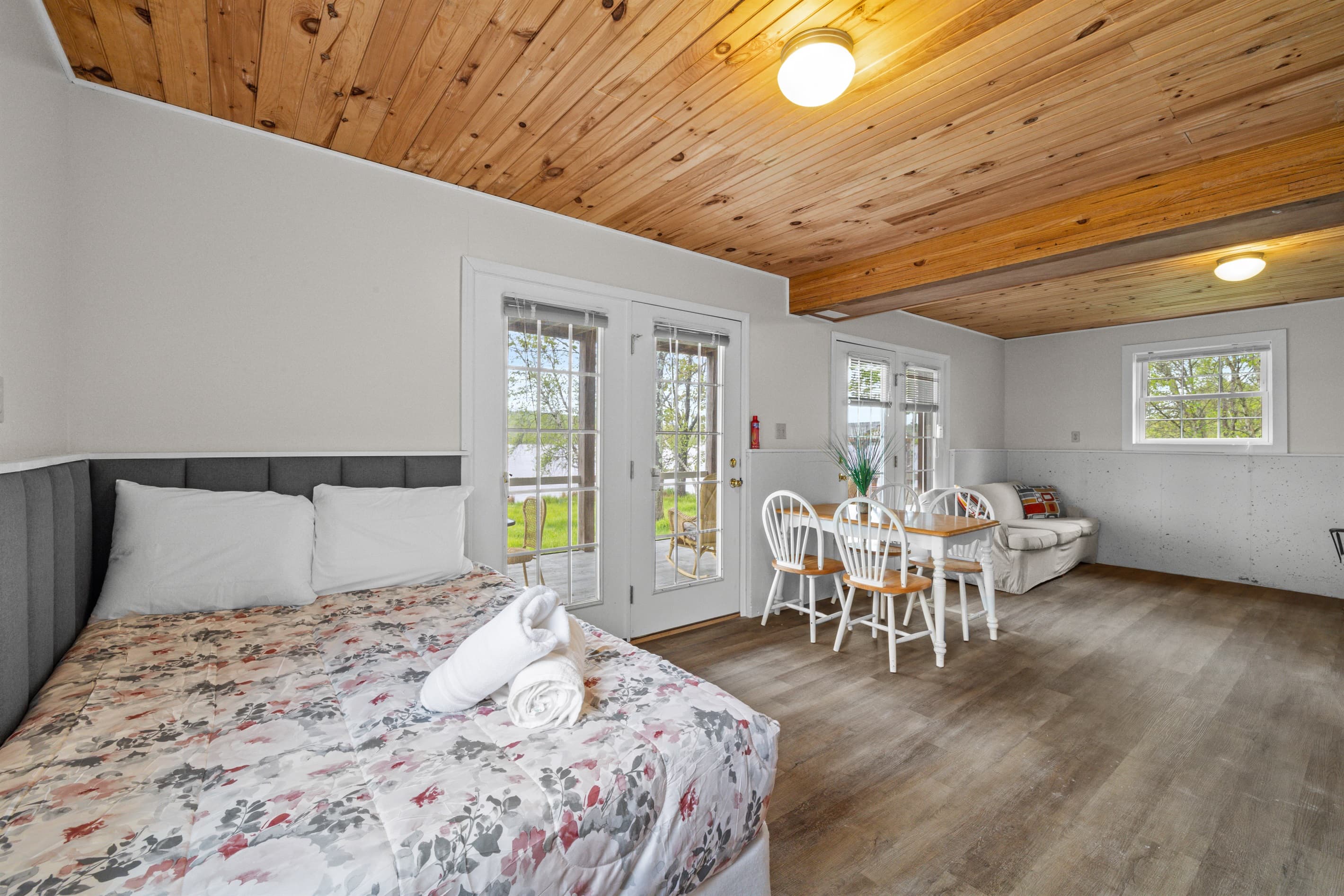 Bonus room offers extra space to spread out, featuring a full-size bed, a cozy TV sofa, and a small dining table—perfect for games, casual meals, or relaxing with a movie.