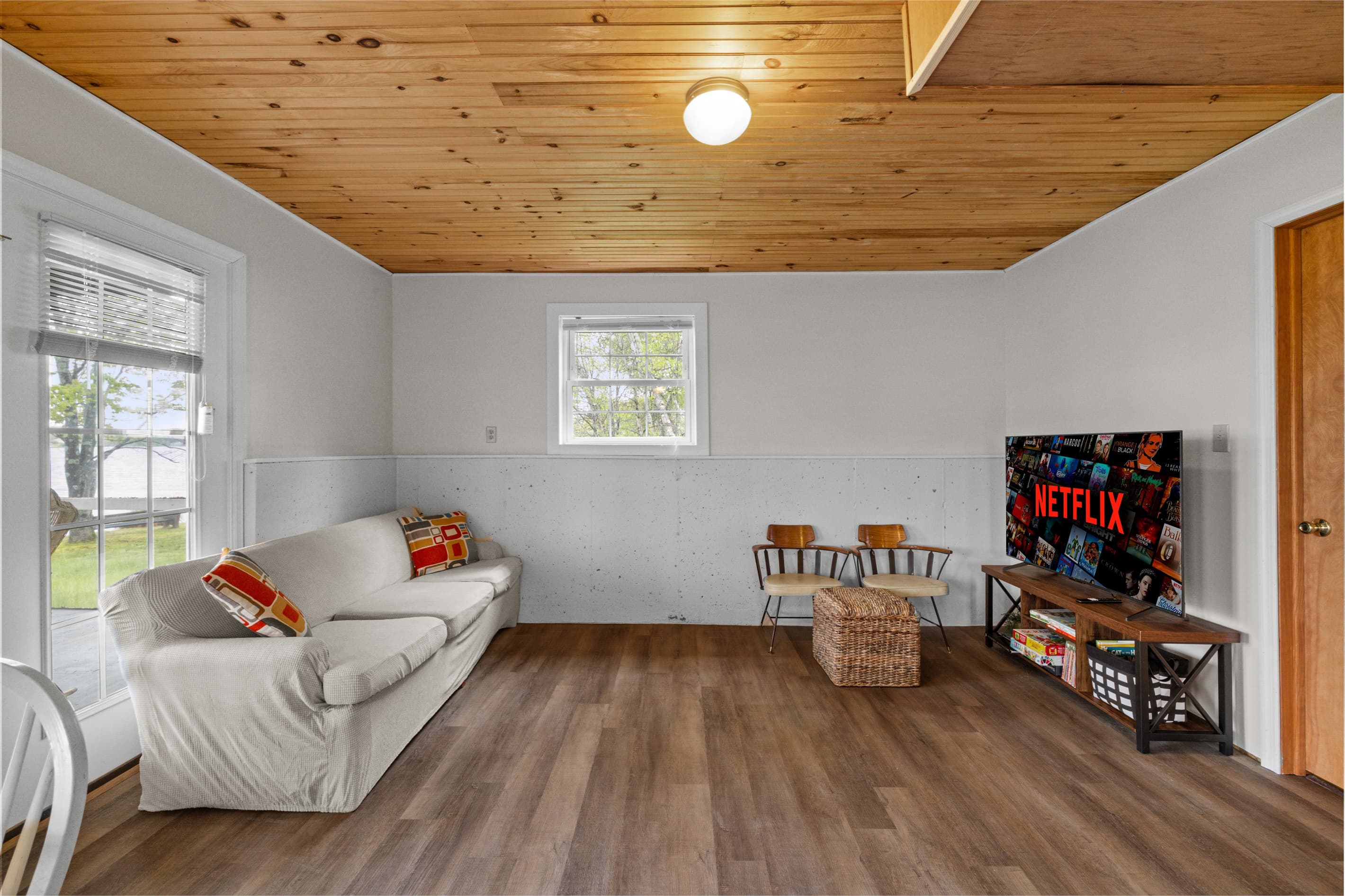 Bonus room offers extra space to spread out, featuring a full-size bed, a cozy TV sofa, and a small dining table—perfect for games, casual meals, or relaxing with a movie.