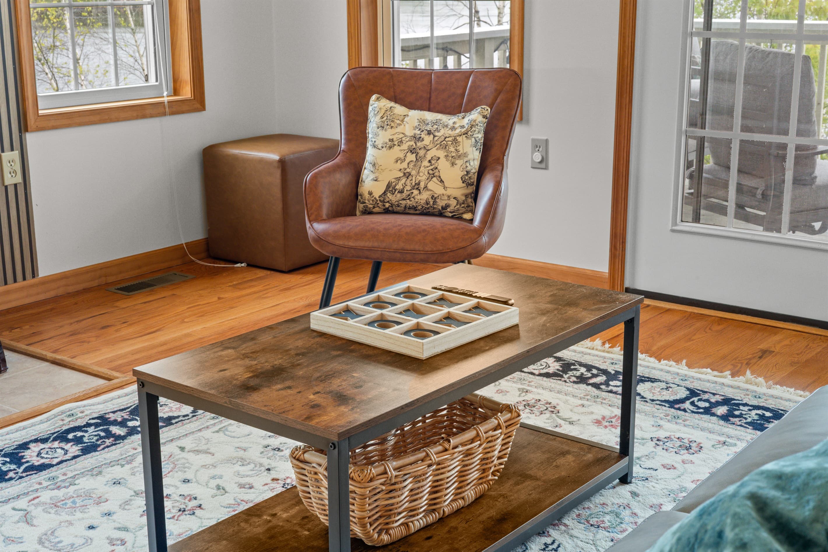Living room with Smart TV to stream favorite shows, comfortable sofa and chairs. Exit to balcony with lakeview