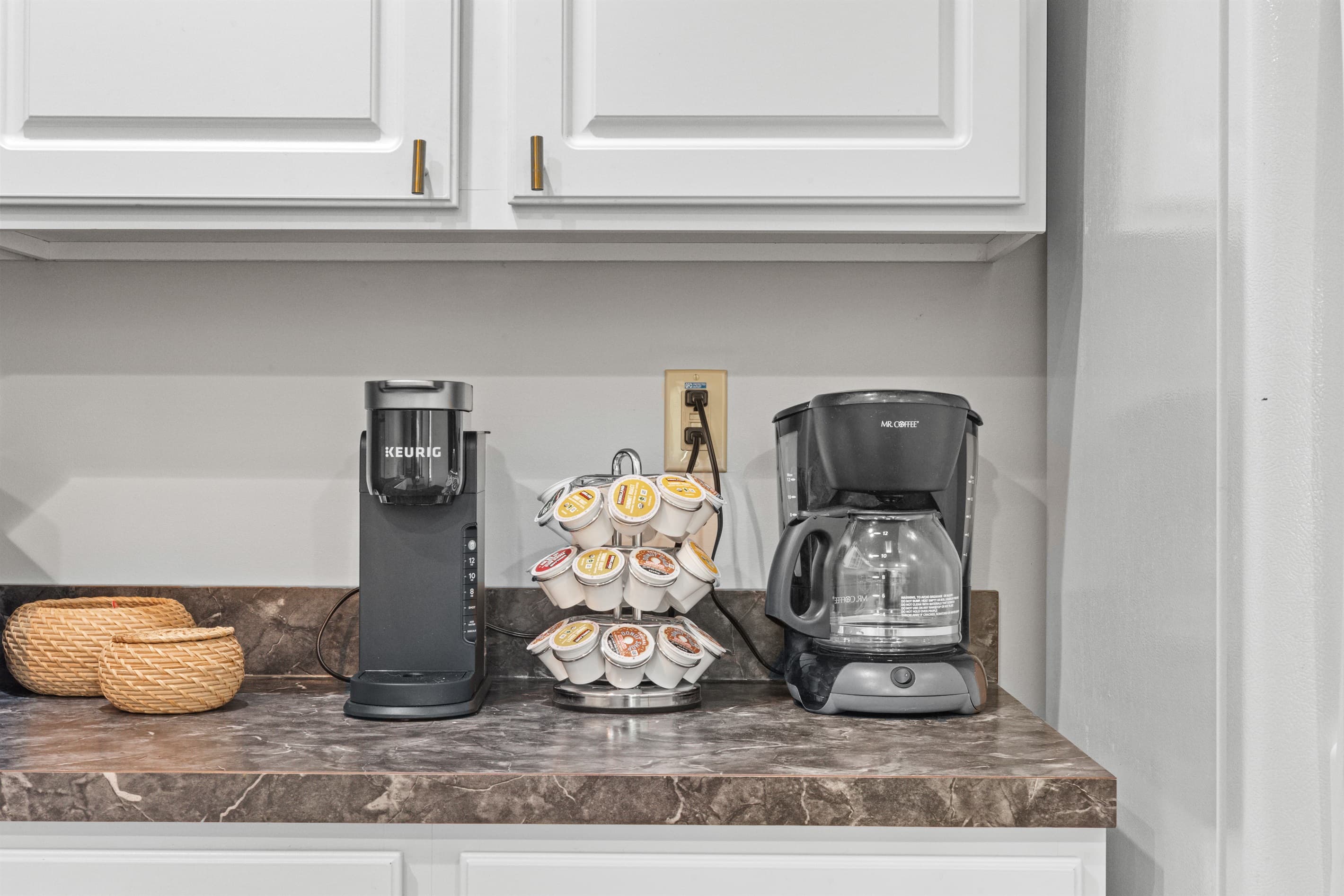 Fully stocked kitchen with white appliances, stainless sink, dishwasher, microwave, toaster, and coffee maker.