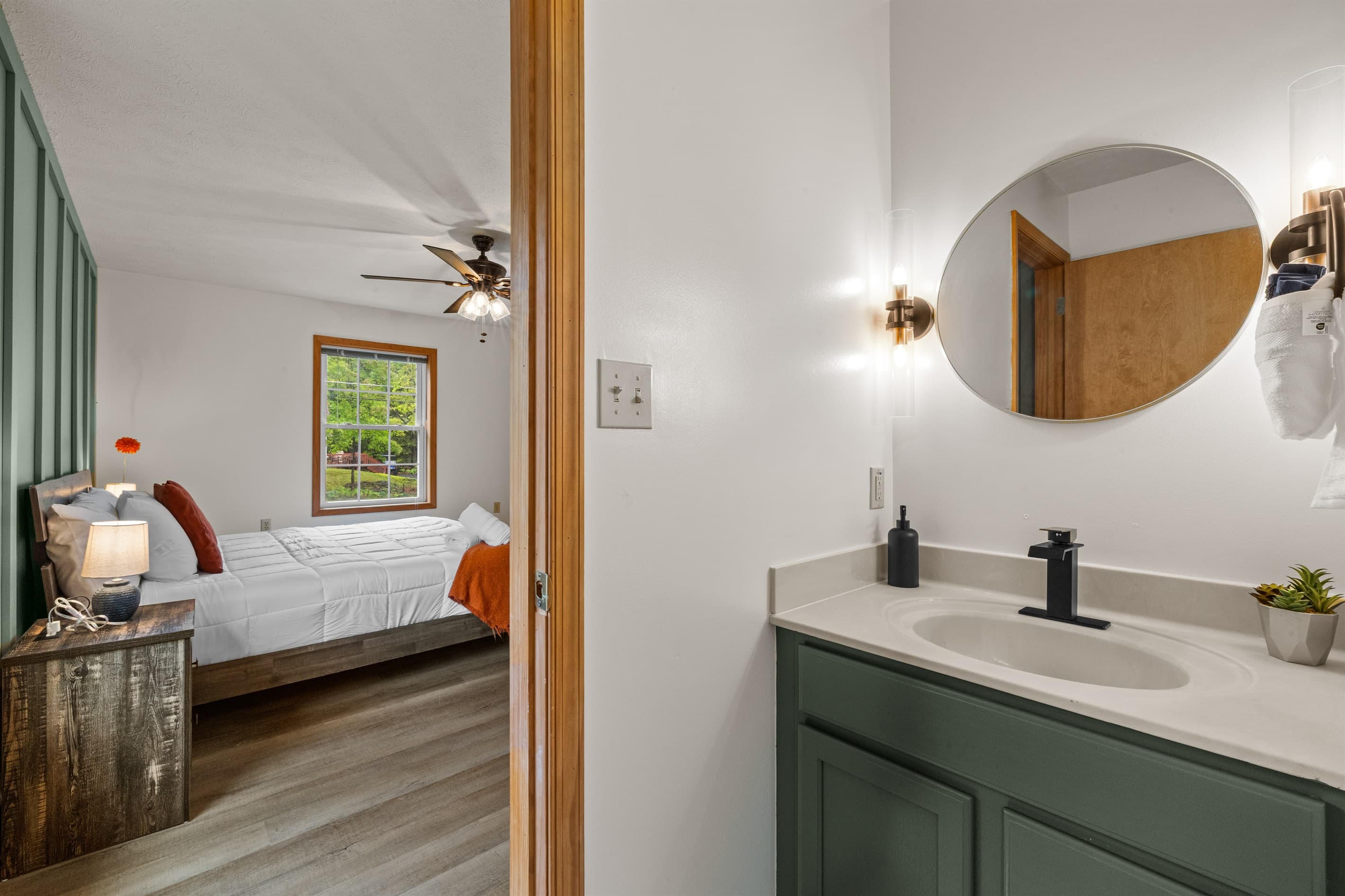 Ensuite bathroom featuring a sink, mirror, toilet, and walk-in shower for convenience and comfort.