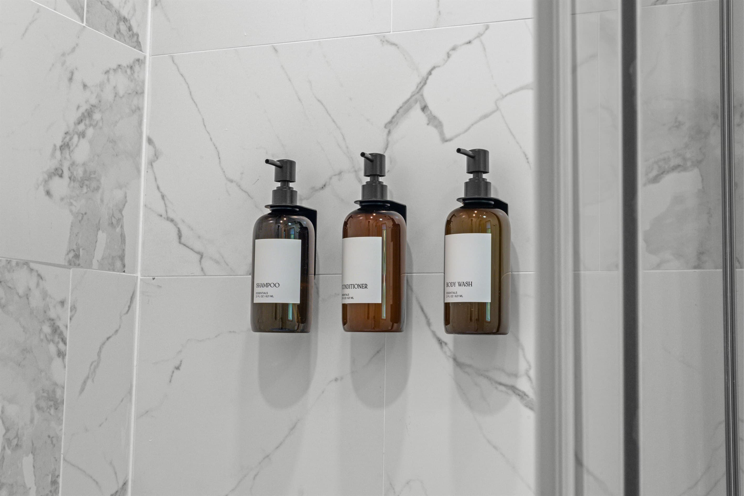 Ensuite bathroom featuring a sink, mirror, toilet, and walk-in shower for convenience and comfort.