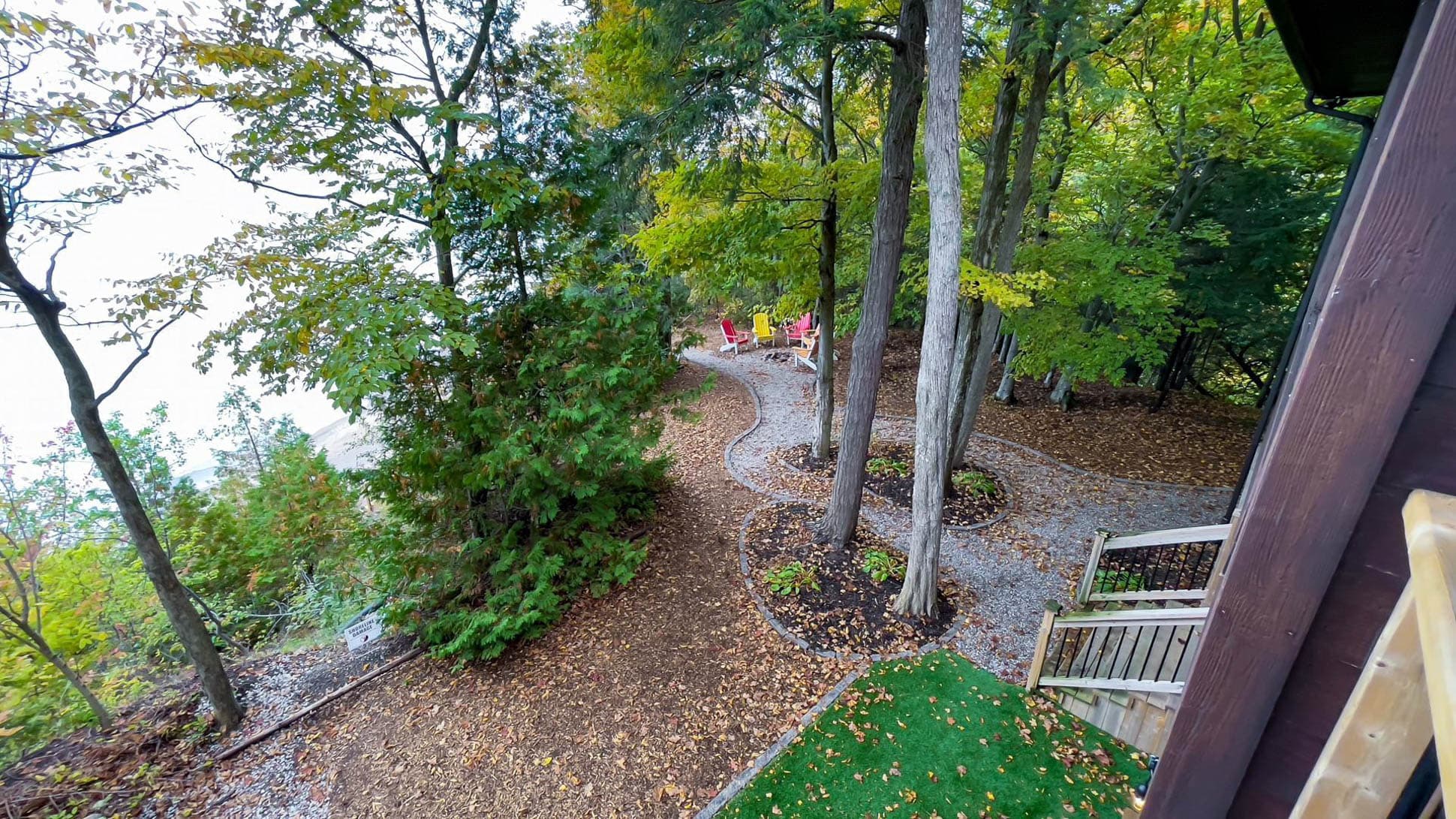 Beautifully landscaped yard with sun and shade a Hammock hangs to the right