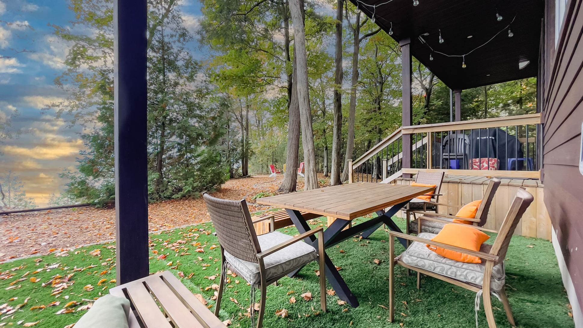 Dine on the teak table with chairs and a bench maximizing views of the lake