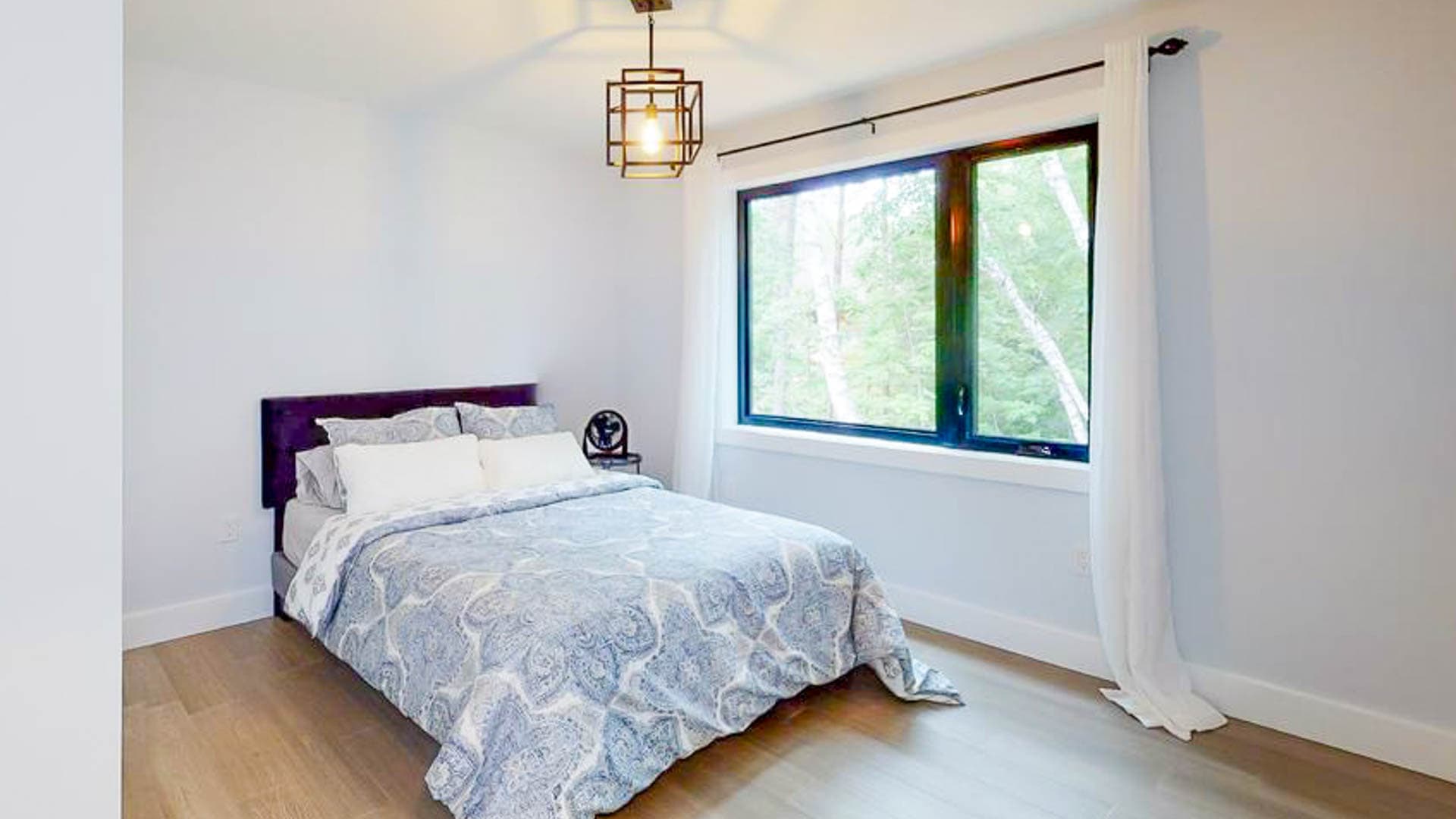 Second bedroom on upper level with queen-sized bed and view