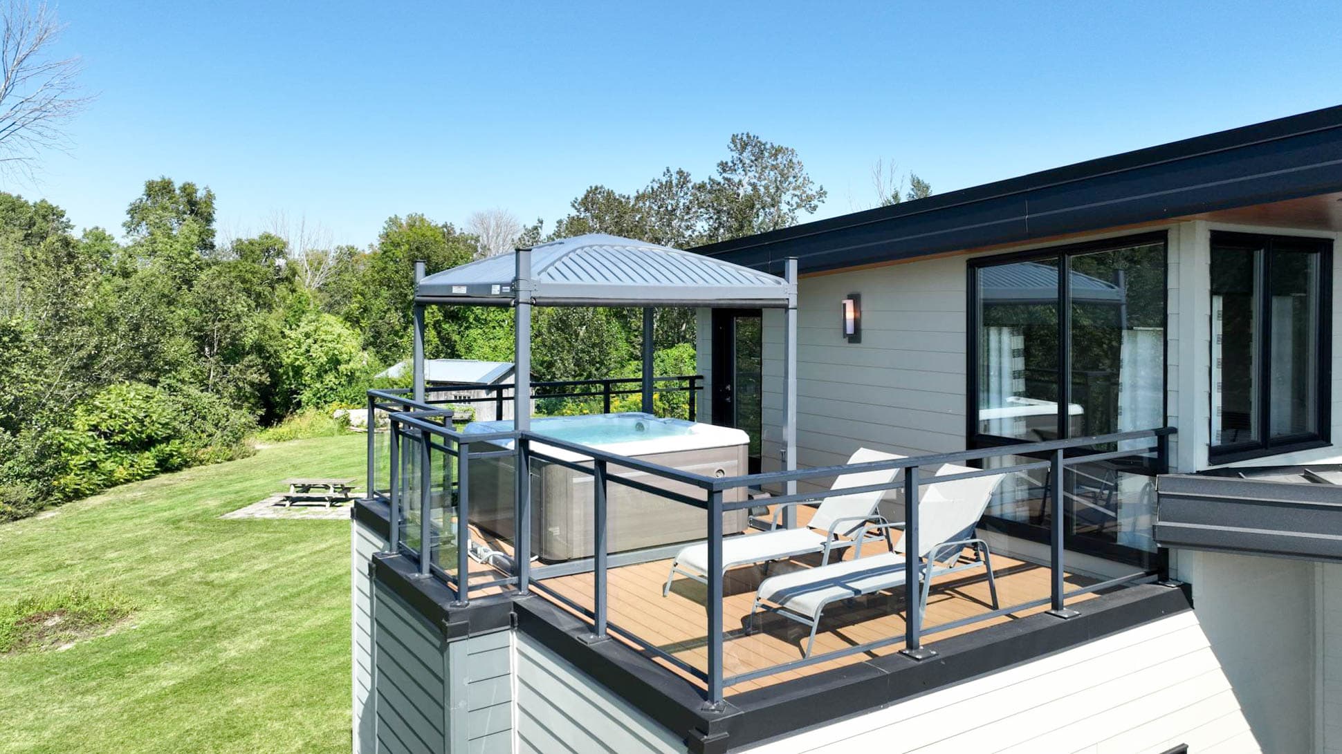 Relaxation elevated: our balcony features a hot tub and lounge area