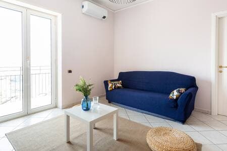 Another shot of the living room with sofa bed and air conditioning