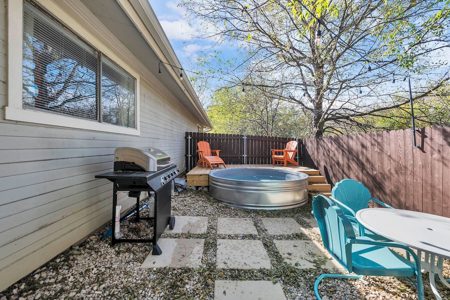 1970s oasis: kick back by the cowboy pool, fire up the grill, and soak in the retro vibes of our rustic backyard retreat.