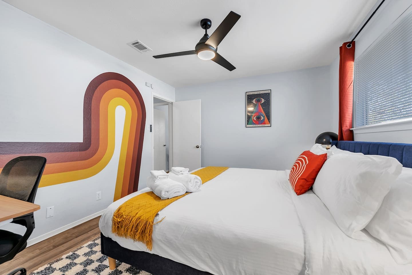 A luxurious king-size bedroom with a pop of color.