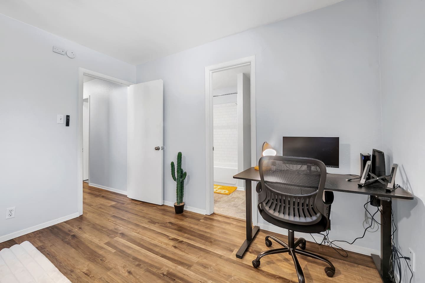 Cozy bedroom with a private bathroom and workspace.