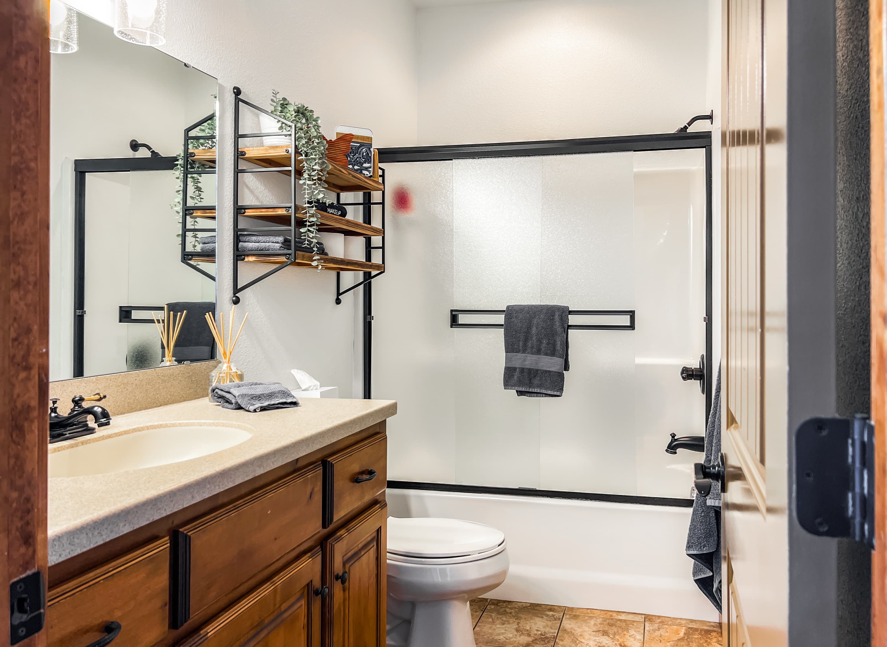 Clean lines and warm wood tones make every bathroom stay comfortable and put-together