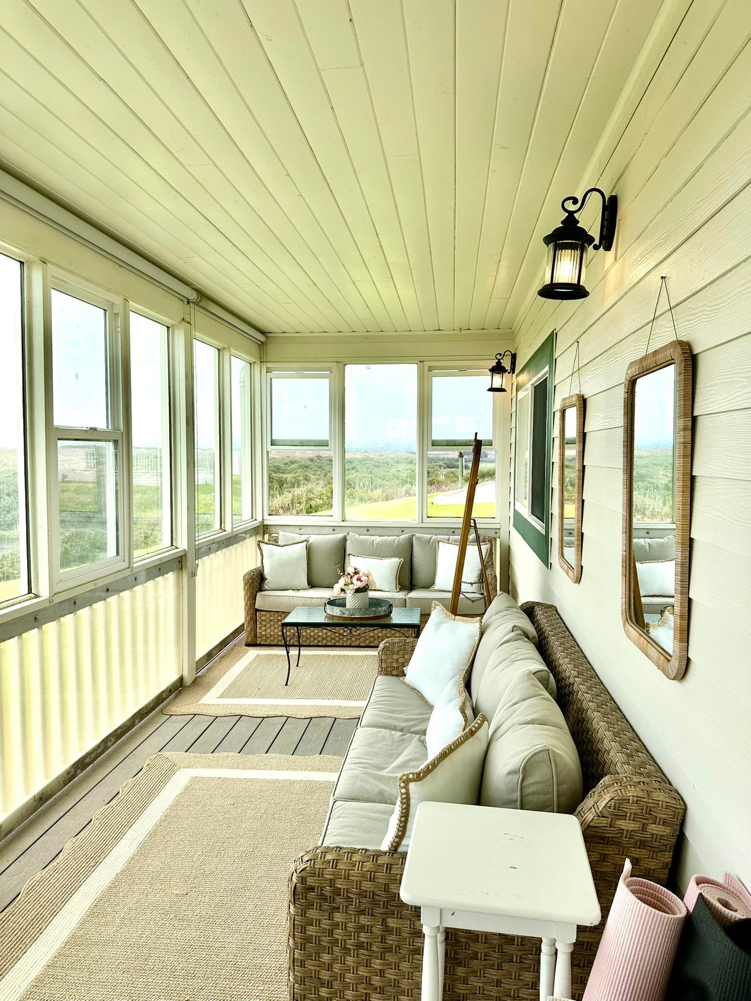 Enclosed sun porch with lake and dune views offers a cozy spot to gather and protection from the occasional coastal wind. 