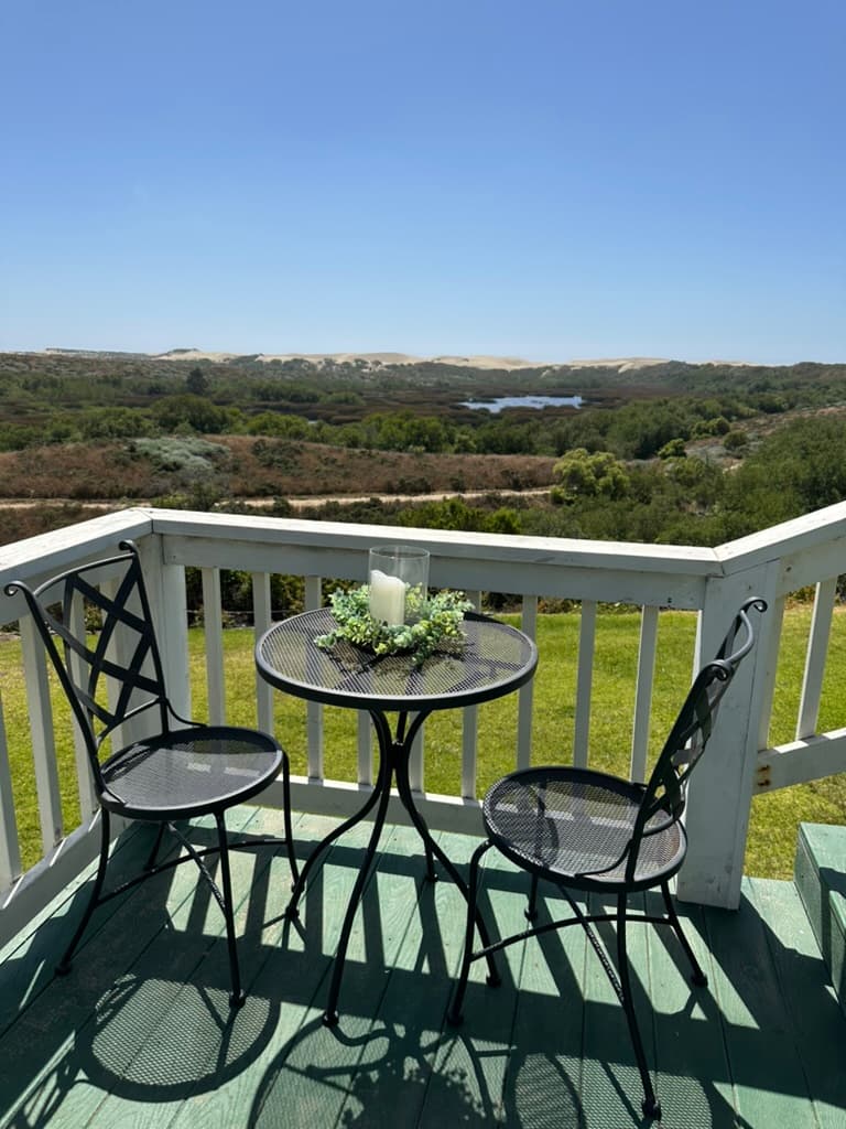 A bistro table and chairs on the landing - perfect spot for morning coffee and pastries or wine and cheese with a stunning sunset.  Your choice.  