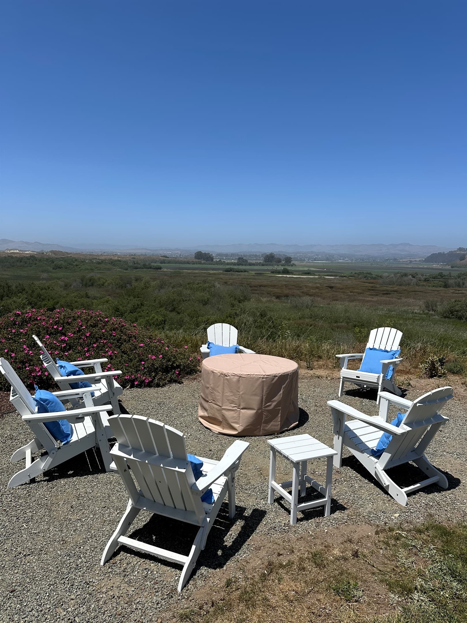 Multiple seating areas on property with Adirondack Chairs and Fire Pits.
