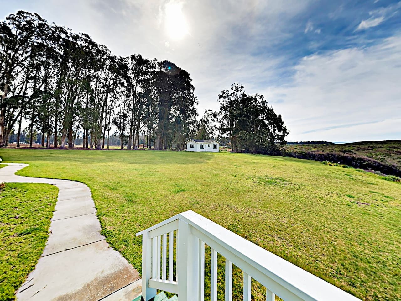 View from side porch toward front of cottage with another 3 bedroom cottage in the distance.  Ask about additional cottages available soon.