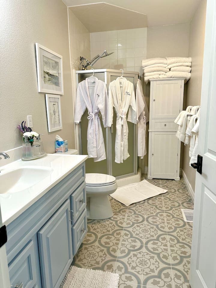 This bathroom had a complete refresh in May 2024! Fluffy towels, monogrammed spa robes for 8 and calm, serene California Coastal decor.  Why settle for just another boring space?