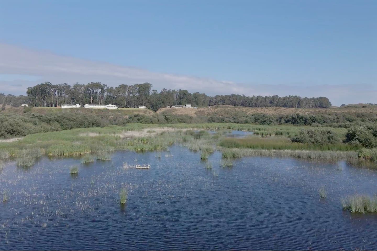 Overhead view (courtsey of a drone) of one of the five lakes with the compound of cottages in the distance.  