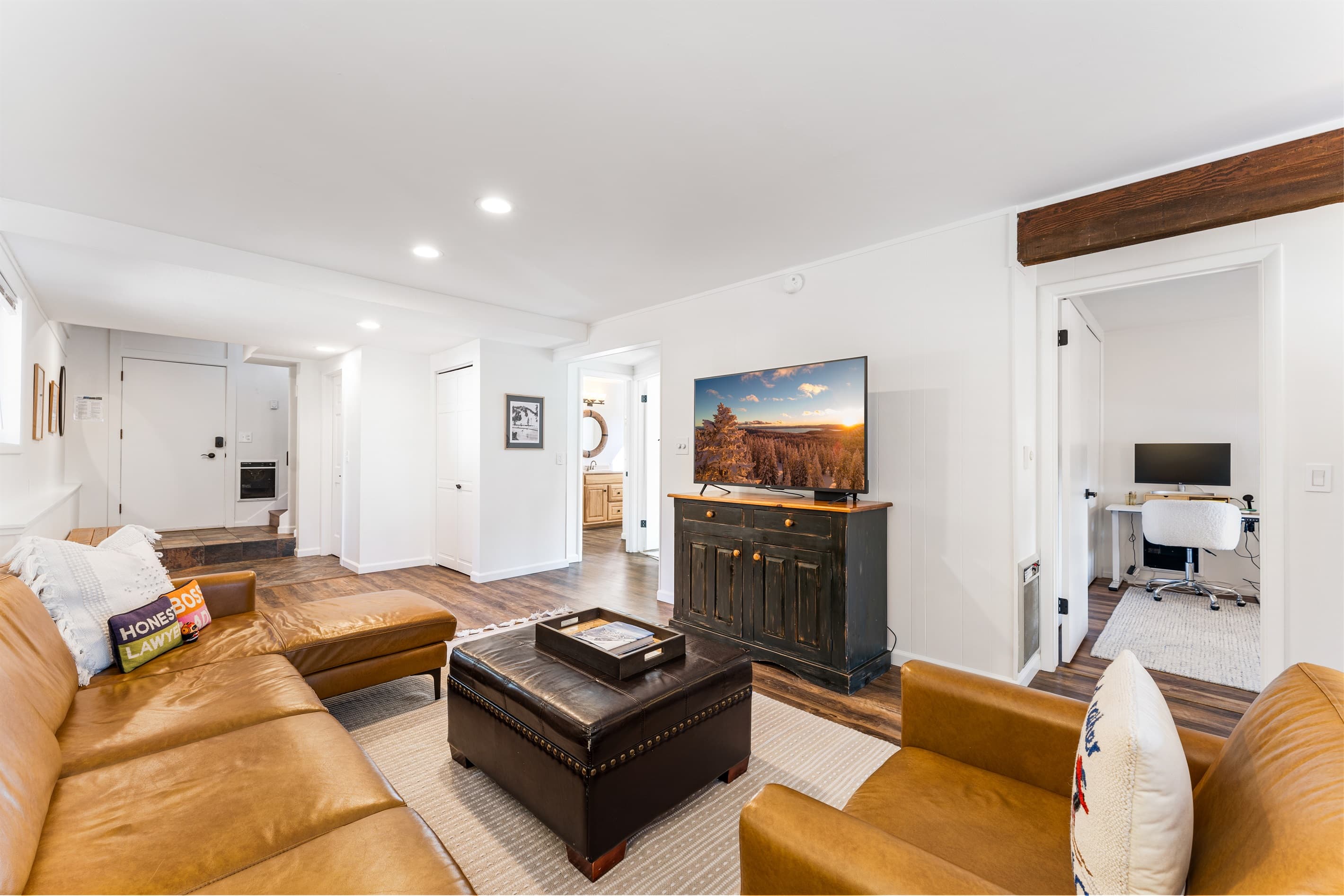 First Floor Living Room - Setup with a gas fireplace, access to the ping pong on the deck and a Smart TV.
