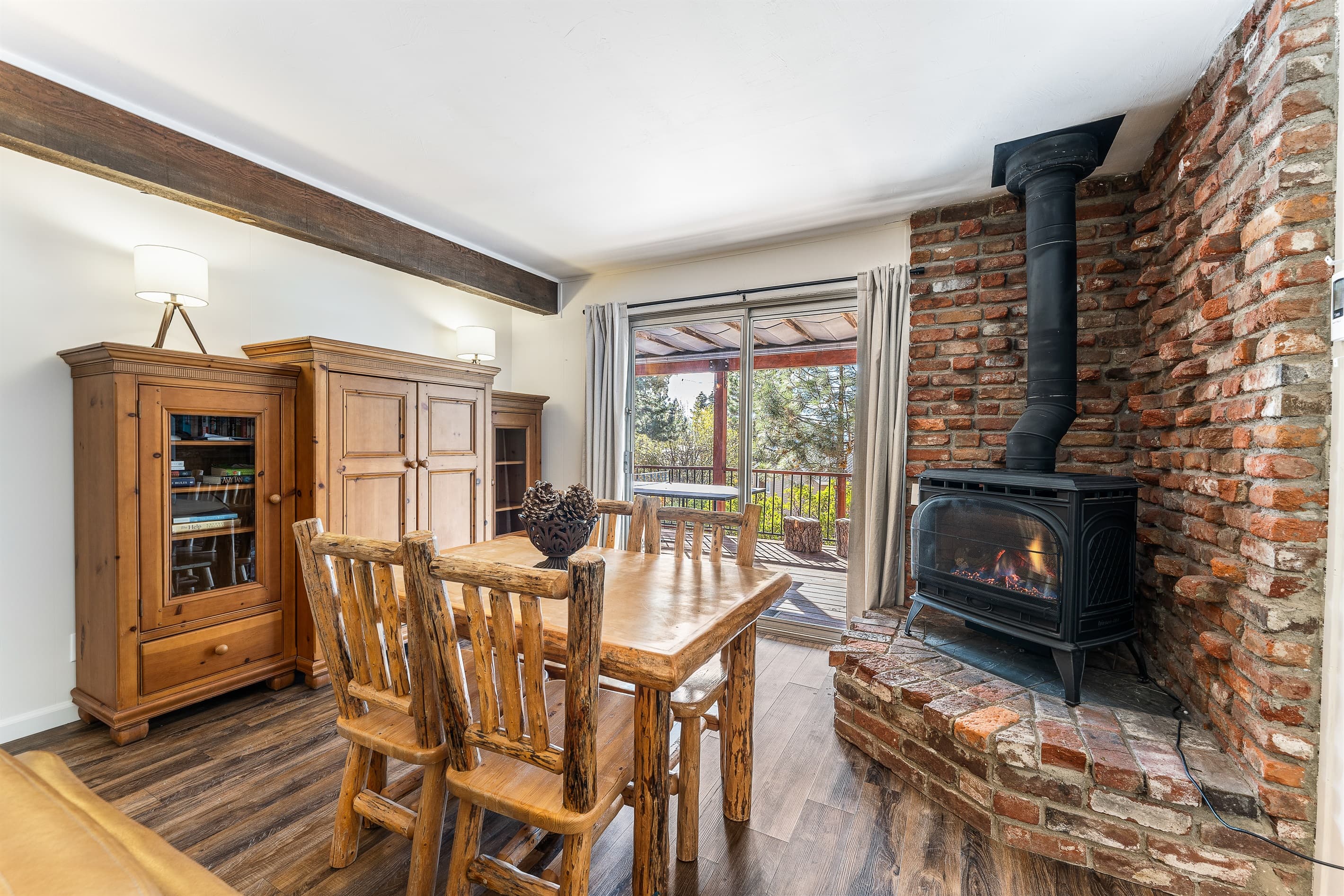 First Floor Living Room - Setup with a gas fireplace, access to the ping pong on the deck and a Smart TV.