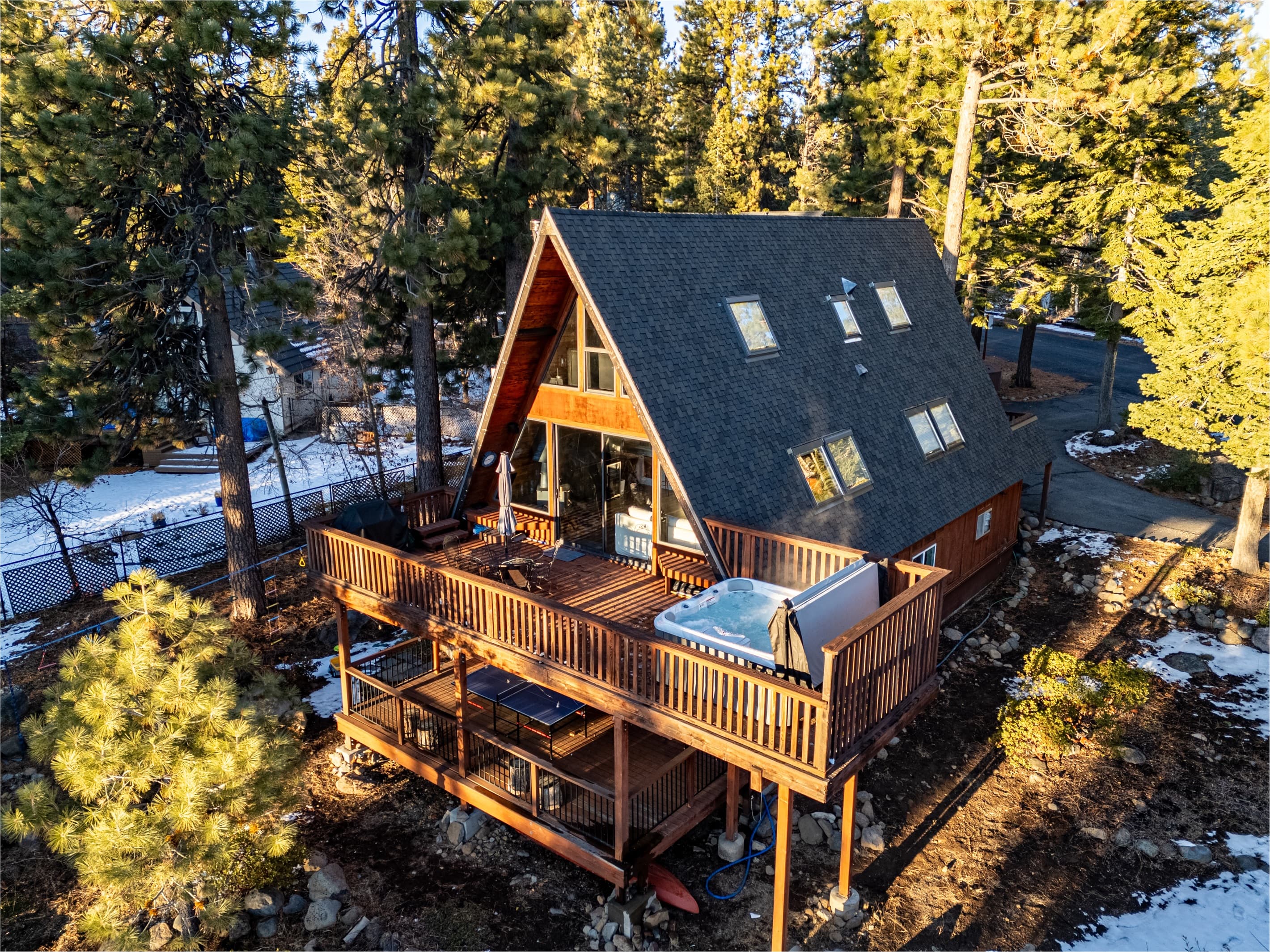 Soak up the sun from the back deck! Enjoy the private hot tub, patio table and BBQ grill. Plus there is a ping pong table underneath the deck.