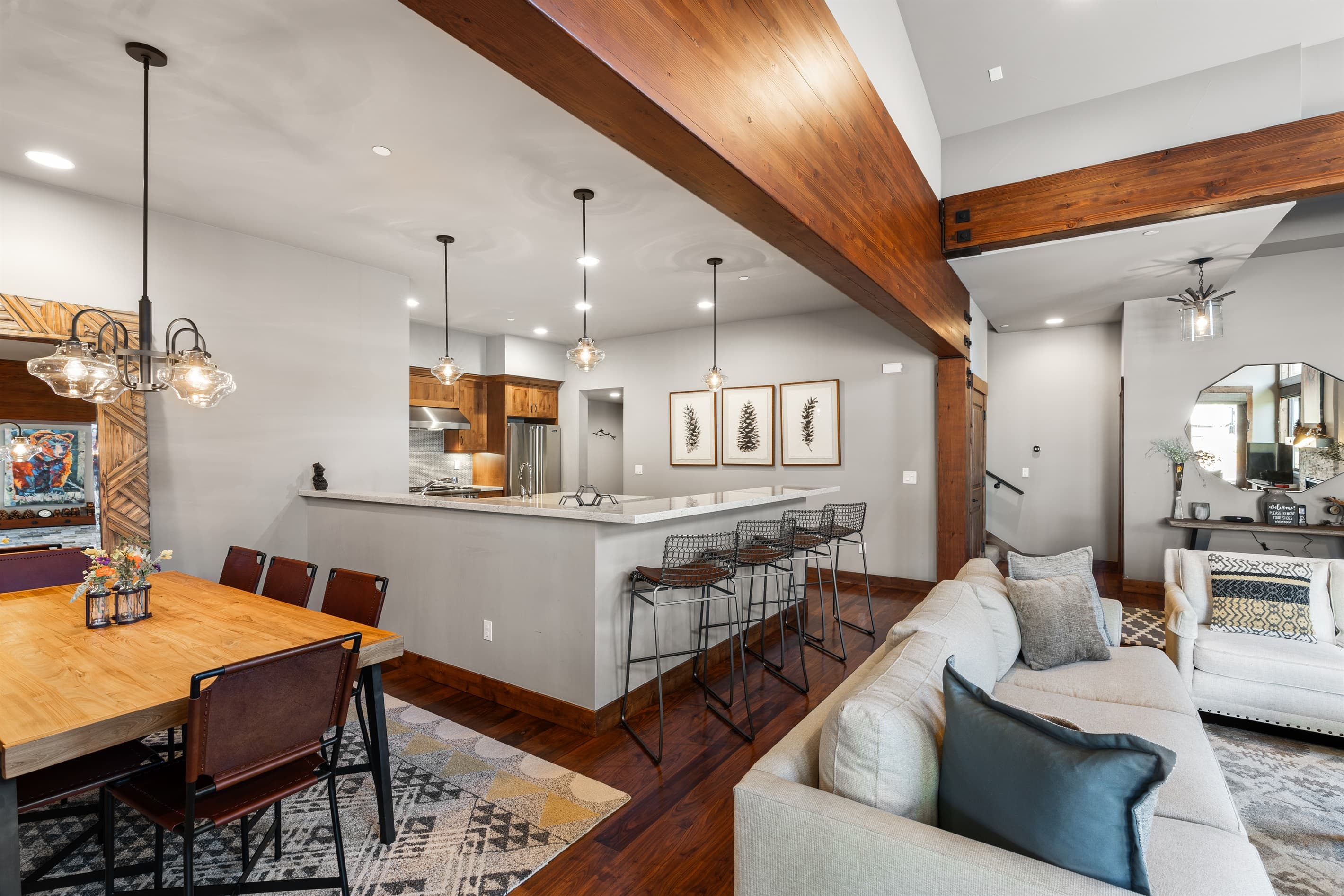 Relax in the inviting great room, where soaring ceilings and large windows flood the space with natural light. Cozy up by the stone fireplace and enjoy the 55" Smart TV.