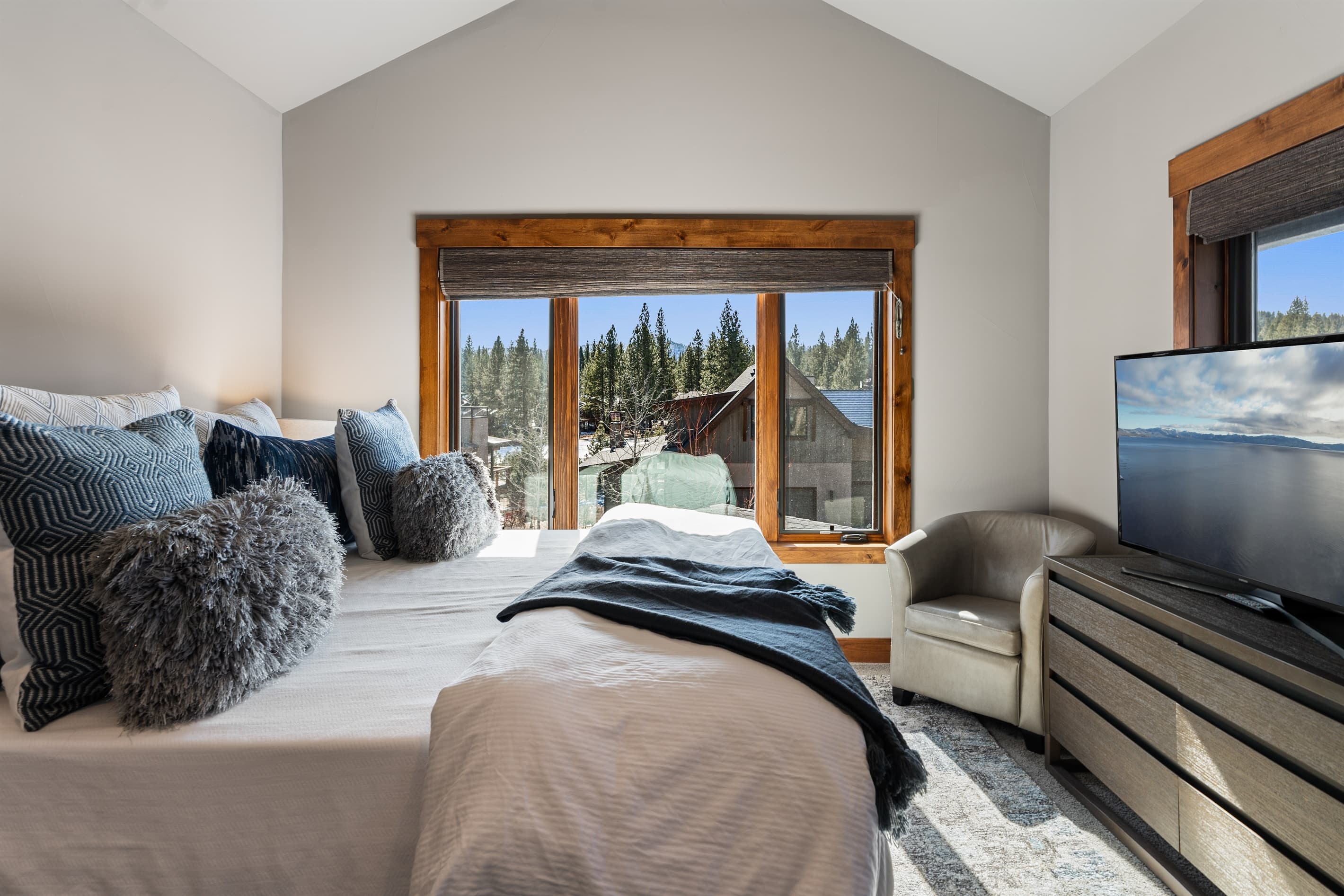 This upstairs luxurious master suite boasts a plush king bed, 49" Smart TV and an en-suite bathroom, making it a serene retreat after a day of Tahoe adventures.