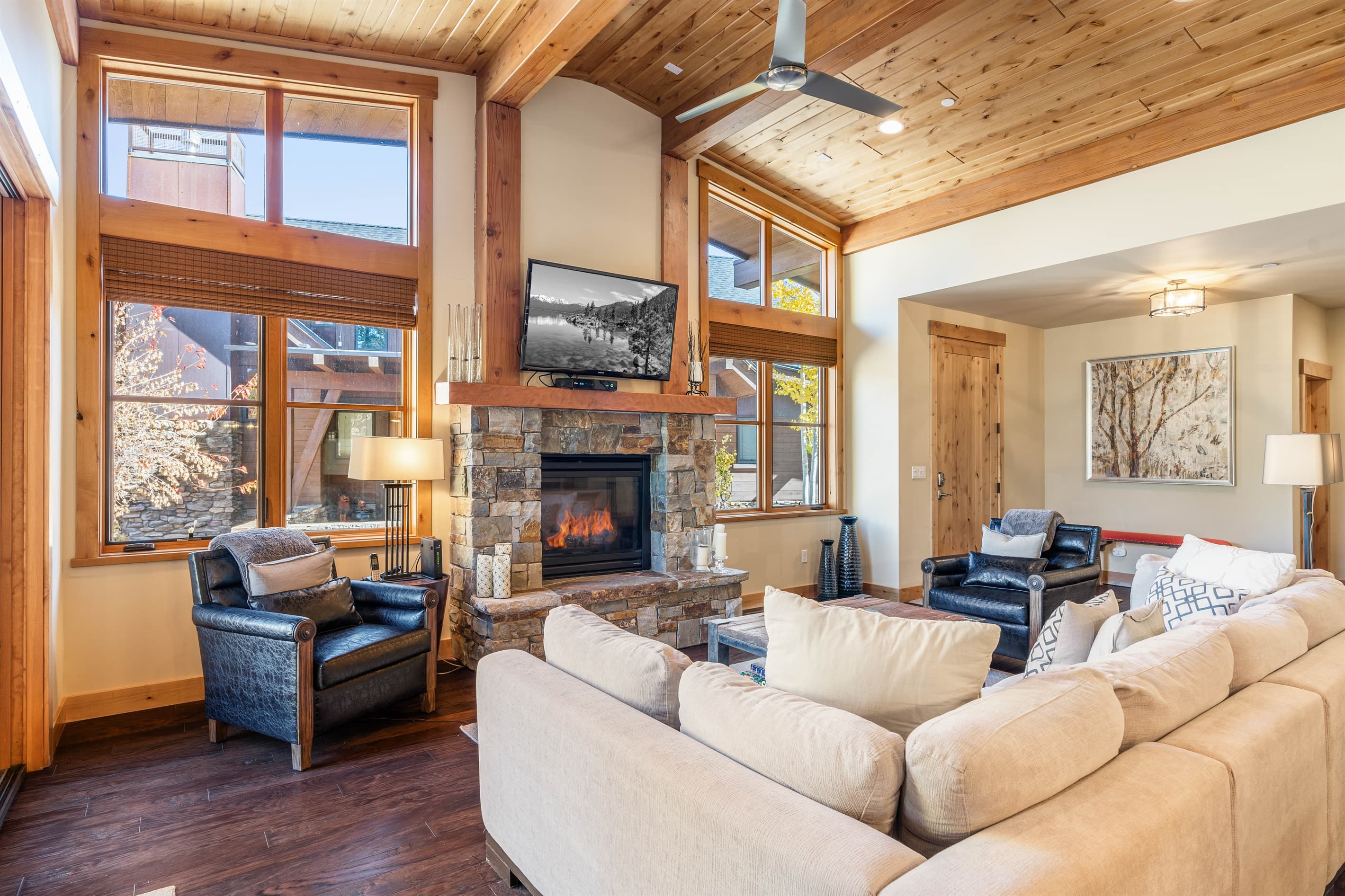 Relax in the inviting great room, where soaring ceilings and large windows flood the space with natural light while framing the picturesque mountain scenery. Cozy up by the stone fireplace and enjoy the 50" TV.