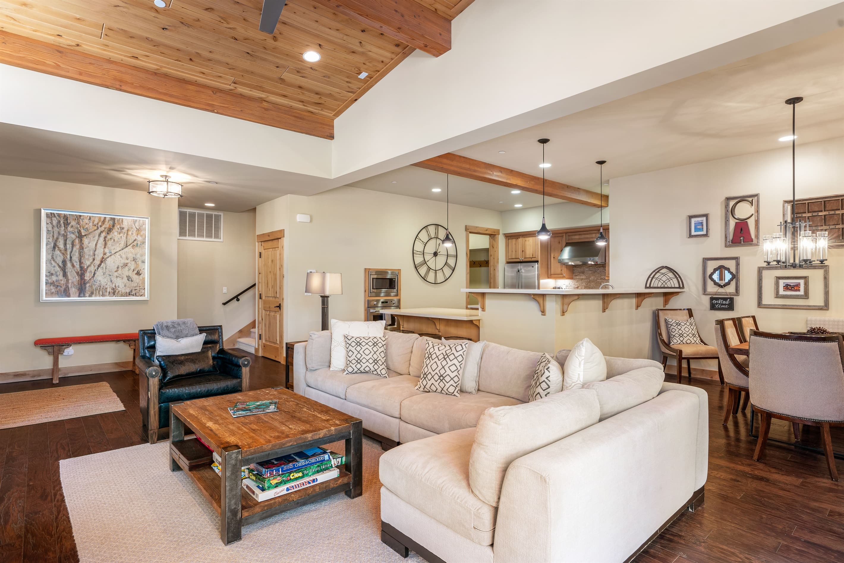 Relax in the inviting great room, where soaring ceilings and large windows flood the space with natural light while framing the picturesque mountain scenery. Cozy up by the stone fireplace and enjoy the 50" TV.