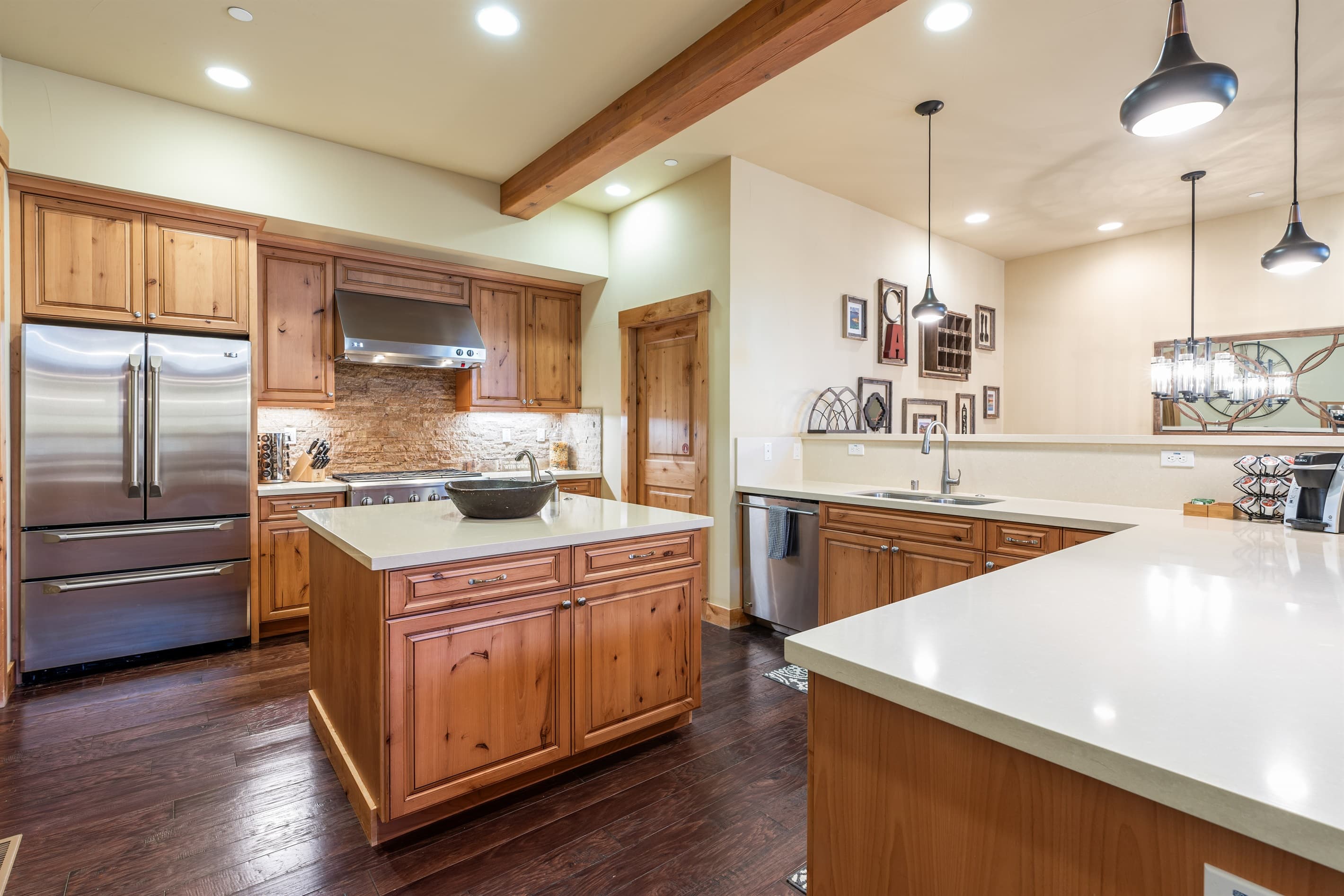 A chef’s dream kitchen with sleek countertops, premium appliances, and a spacious island ideal for cooking, gathering, and casual meals. Countertop seating for 3 people.