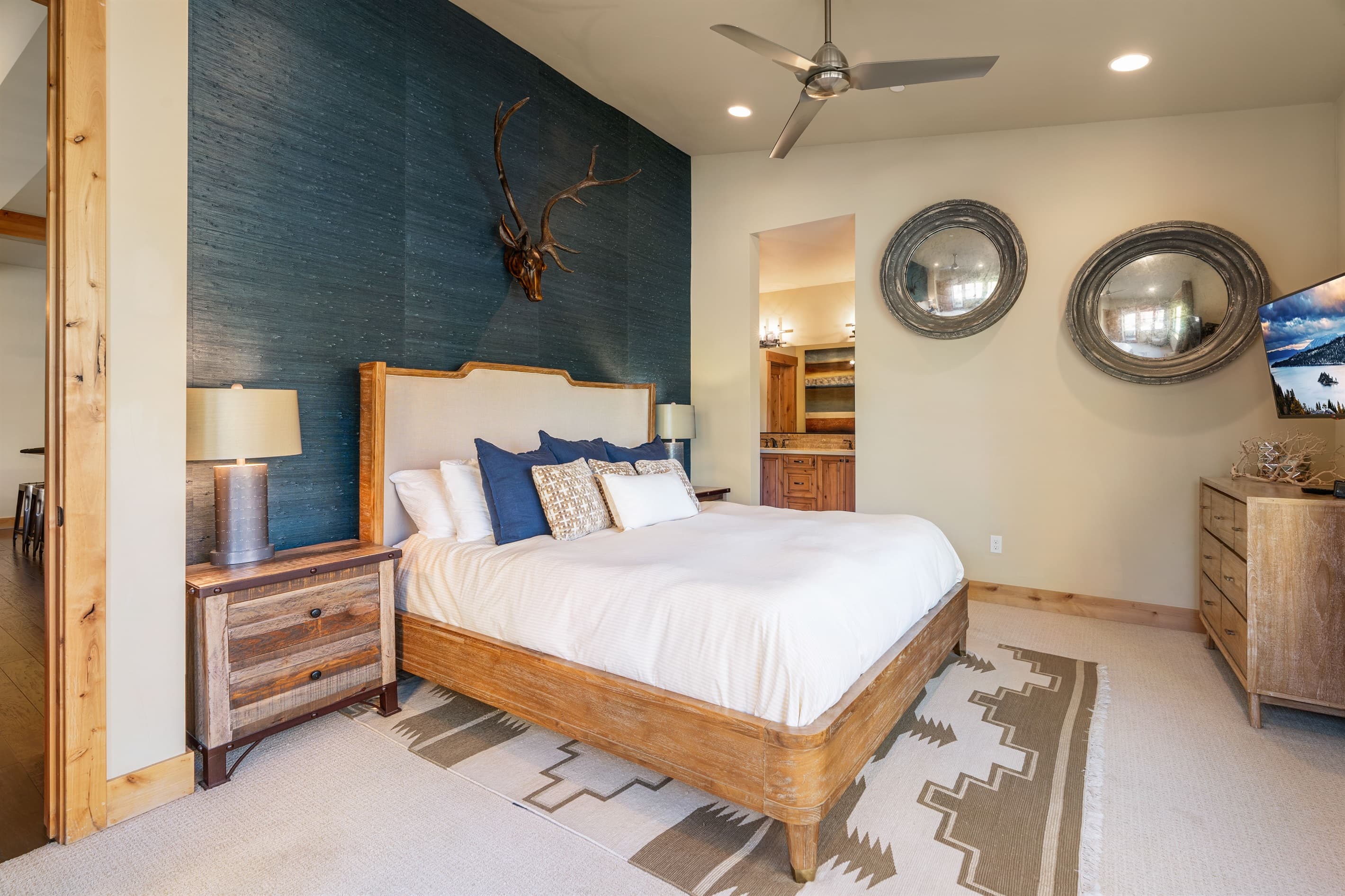Located on the first floor, the luxurious master suite boasts a plush king bed and an en-suite bathroom, making it a serene retreat after a day of Tahoe adventures.