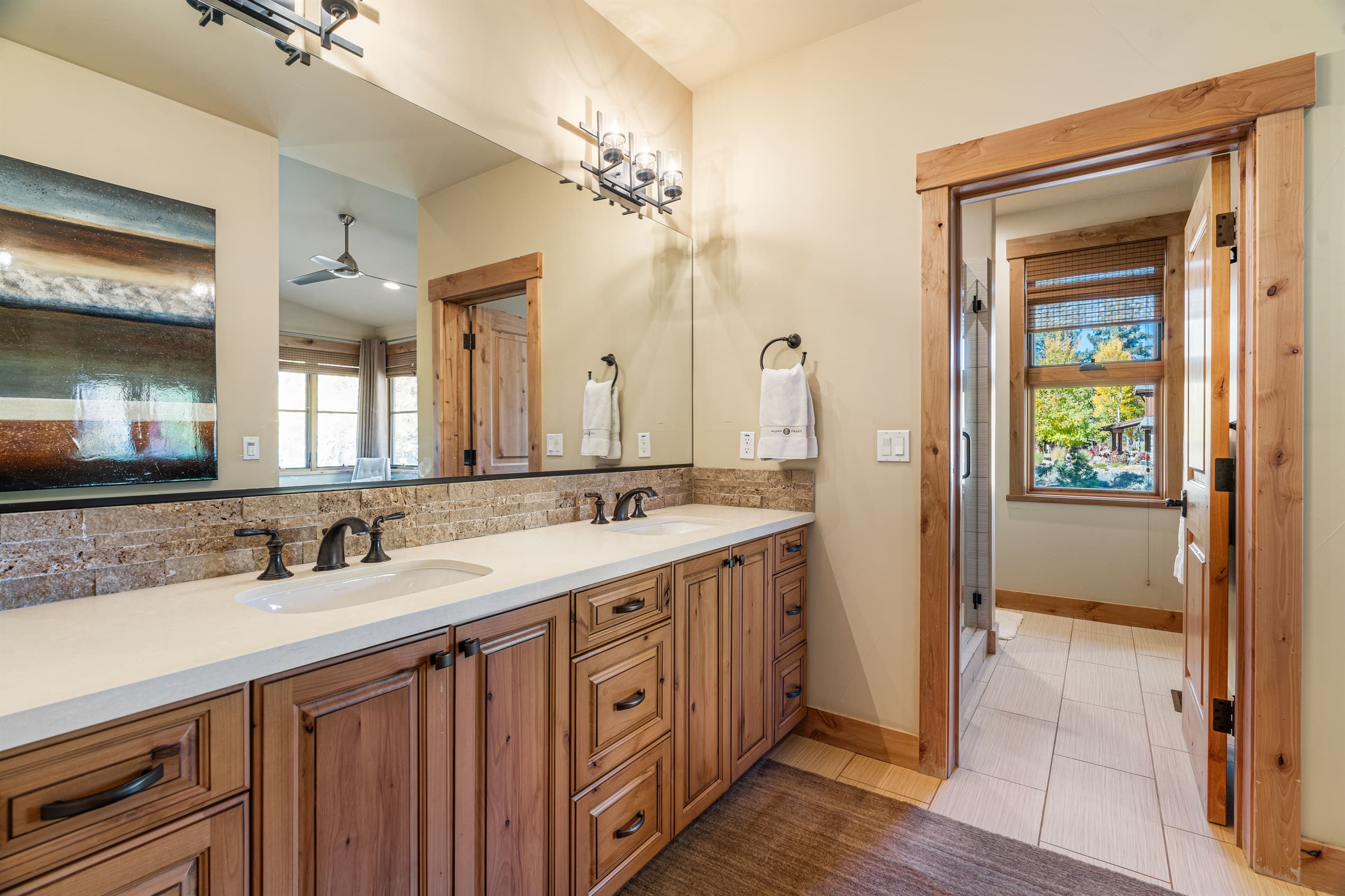 The primary bathroom offers a walk-in closet, dual vanities, and a spacious walk-in shower, creating a serene space designed for relaxation. Stocked with towels, hand soap, shampoo, conditioner, body wash and toilet paper.