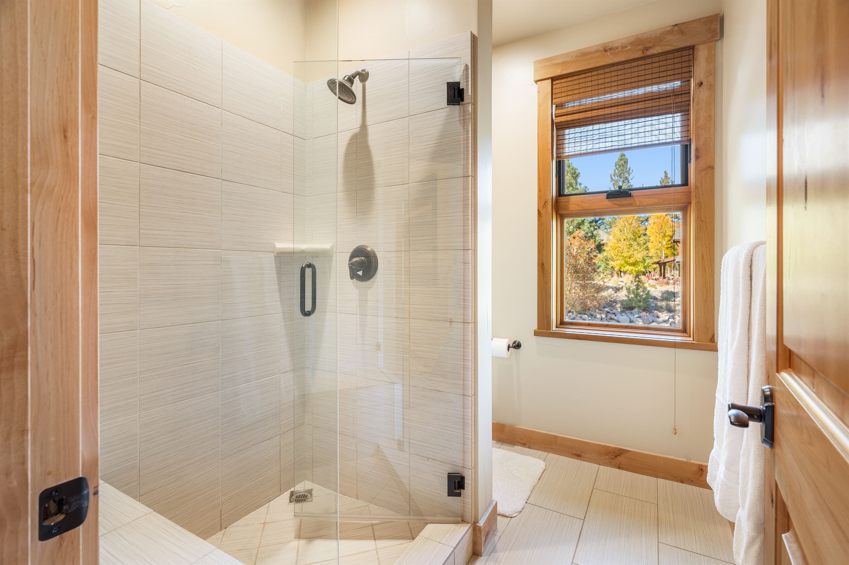 The primary bathroom offers a walk-in closet, dual vanities, and a spacious walk-in shower, creating a serene space designed for relaxation. Stocked with towels, hand soap, shampoo, conditioner, body wash and toilet paper.