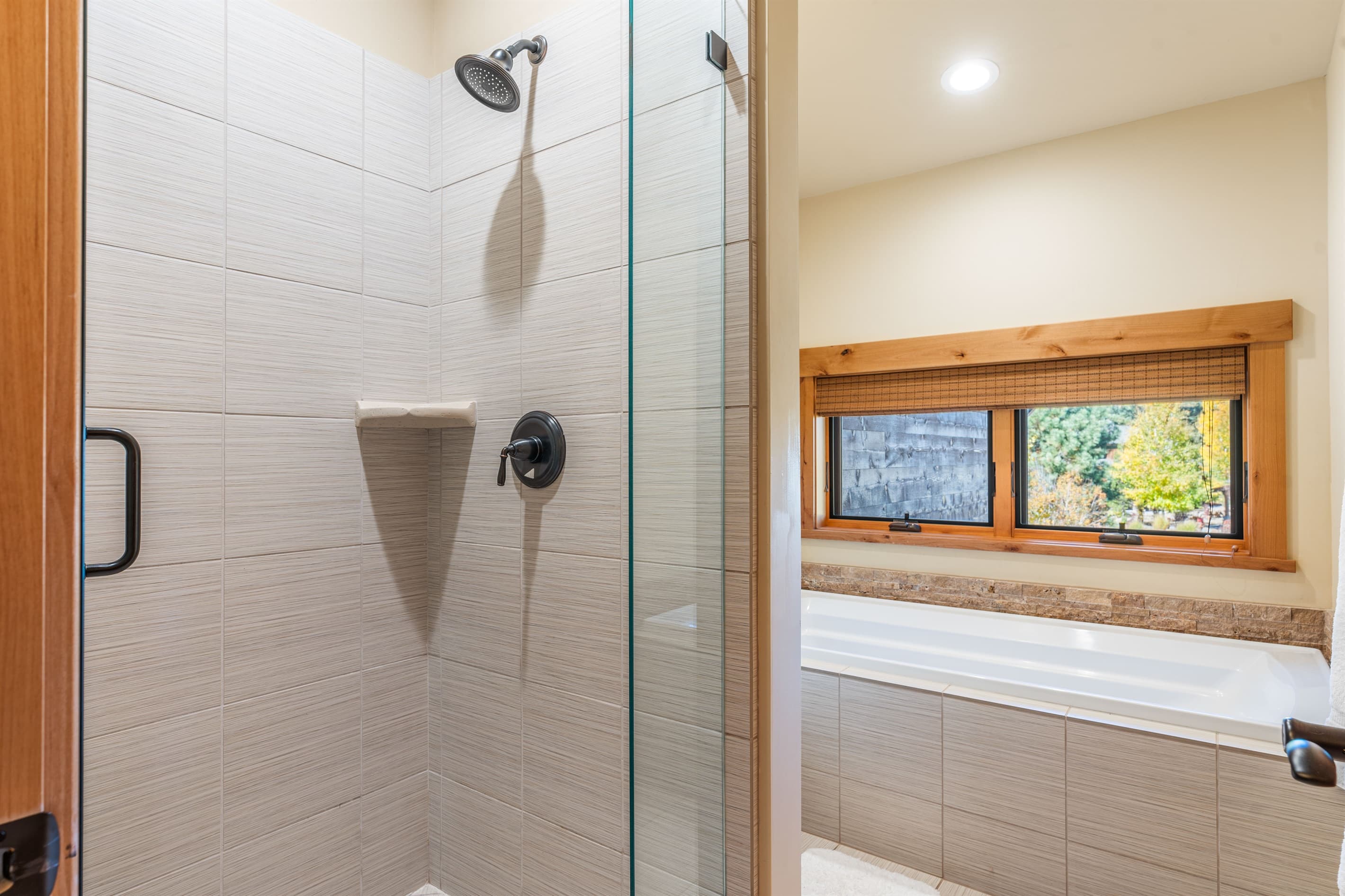 The upstairs bathroom offers a soaking tub, walk-in closet, dual vanities, and a spacious walk-in shower, creating a serene space designed for relaxation. Stocked with towels, hand soap, shampoo, conditioner, body wash and toilet paper.