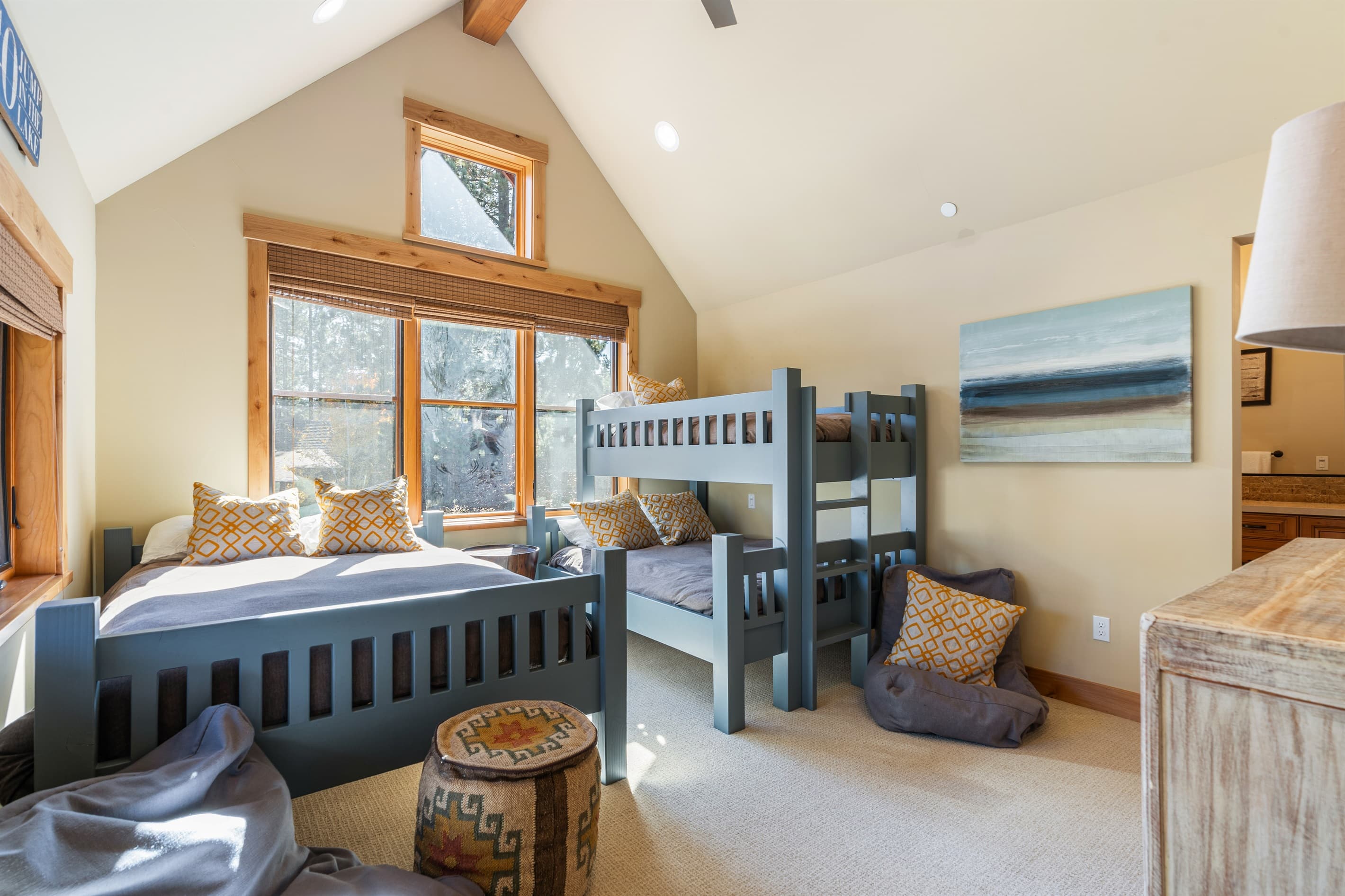 The bunk room is perfect for families or groups, featuring queen bed and a twin-over-queen bunk bed to comfortably accommodate guests of all ages. With its own en-suite bathroom, this space offers convenience and privacy.