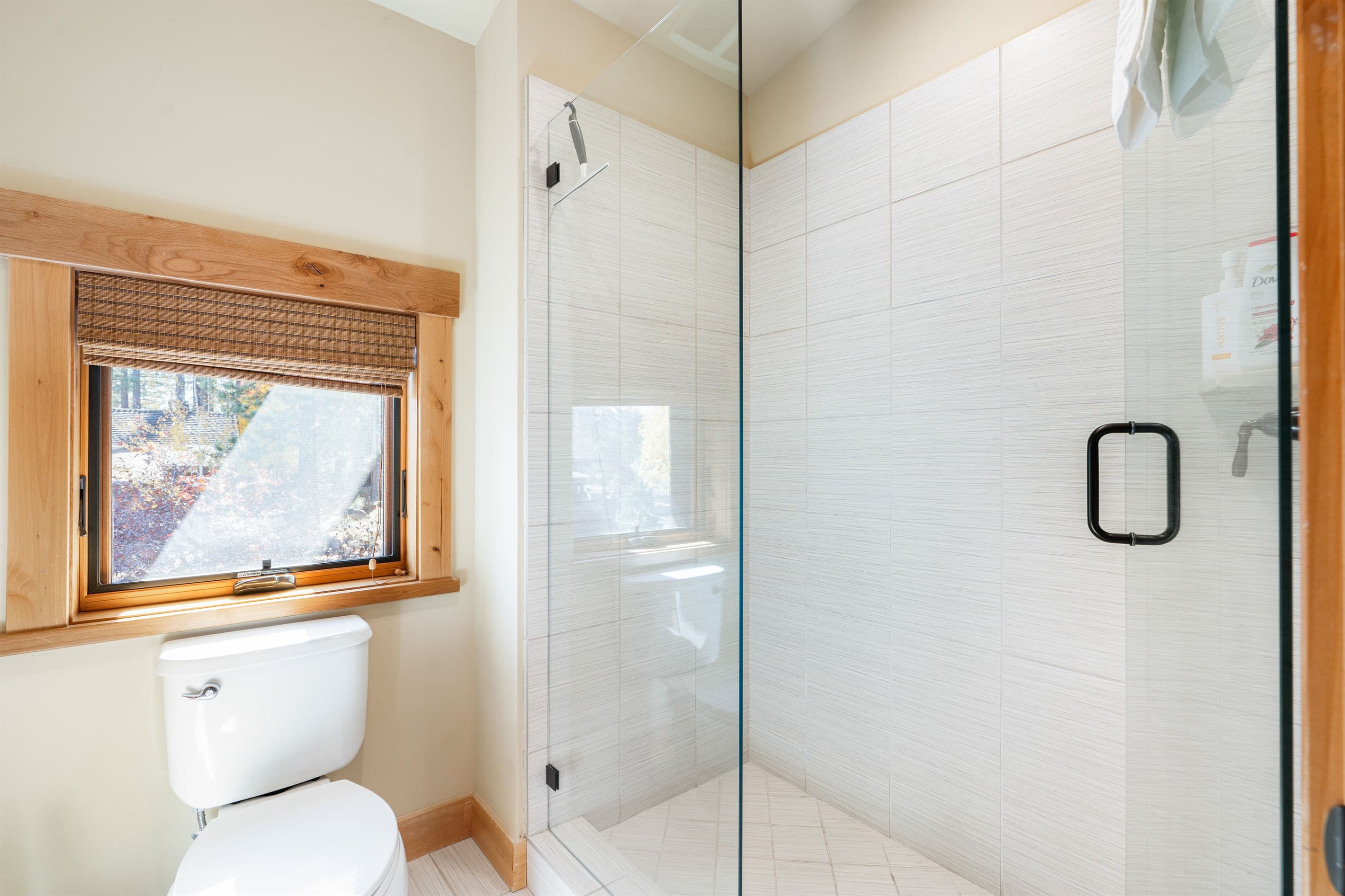 The bunk room bathroom offers a walk-in closet, dual vanities, and a spacious walk-in shower, creating a serene space designed for relaxation. Stocked with towels, hand soap, shampoo, conditioner, body wash and toilet paper.