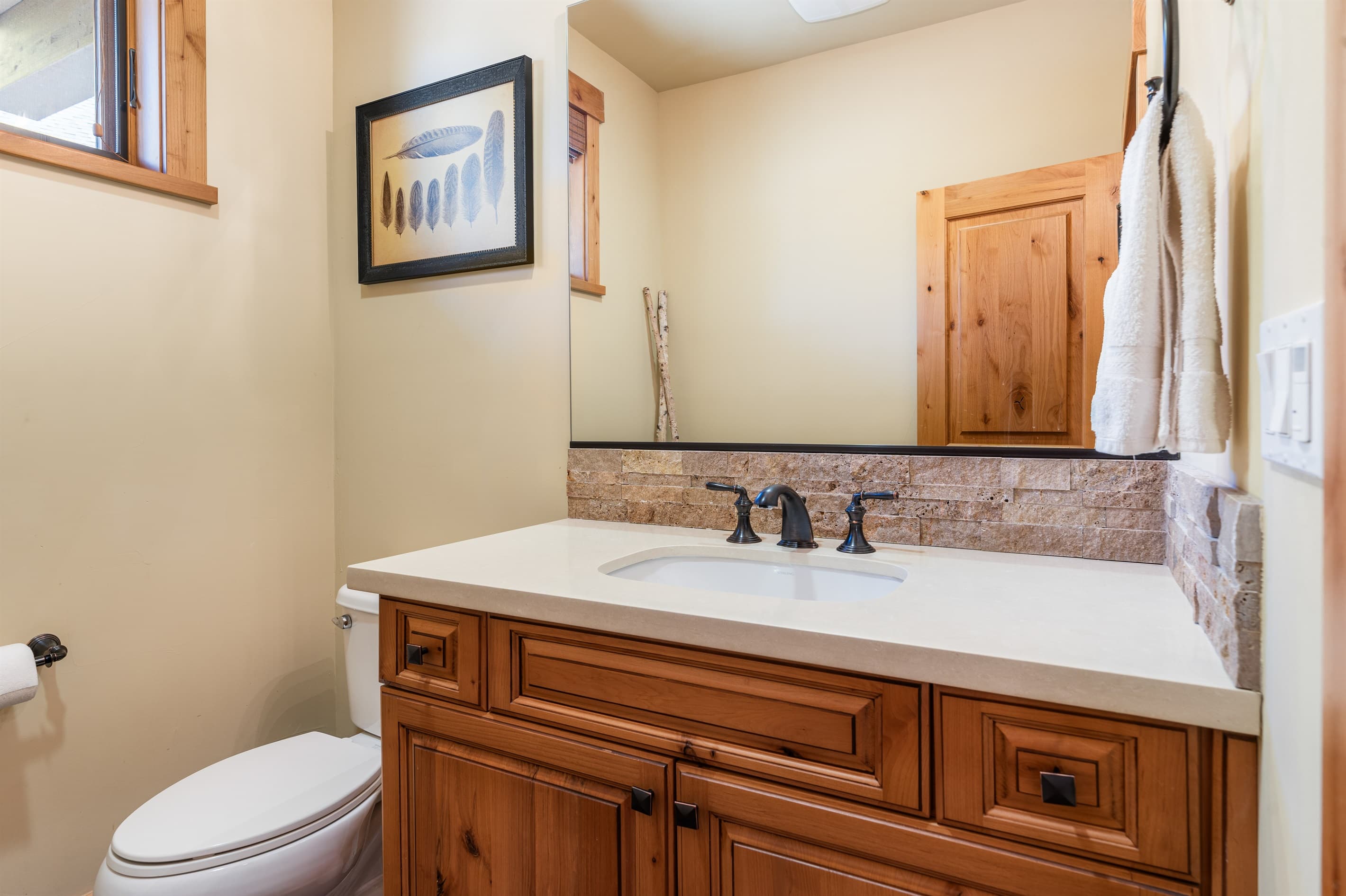 This half bathroom features a single vanity and is thoughtfully stocked with ample hand soap and toilet paper for a comfortable stay.