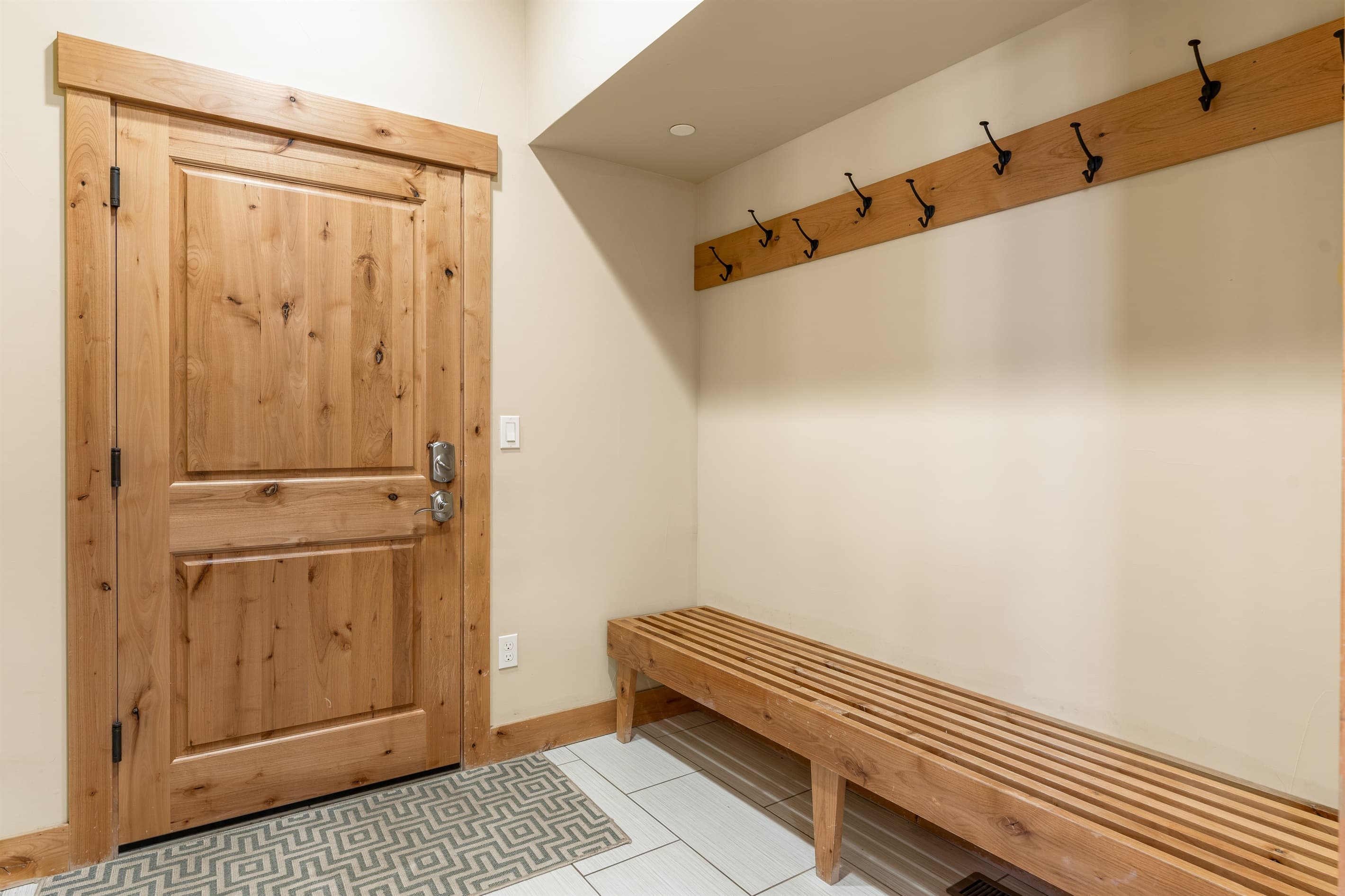 Entering from the garage, the mud room connects directly to the kitchen and offers the perfect spot for hanging coats and jackets and storing shoes.