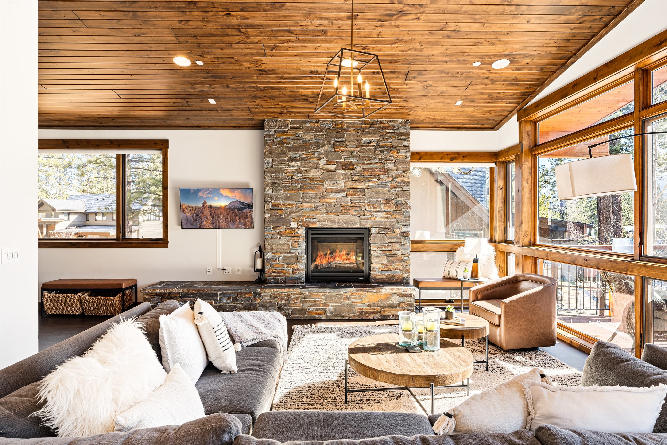 Relax in the inviting great room, where soaring ceilings and large windows flood the space with natural light while framing the picturesque mountain scenery. Cozy up by the stone fireplace and enjoy the 50" Smart TV.