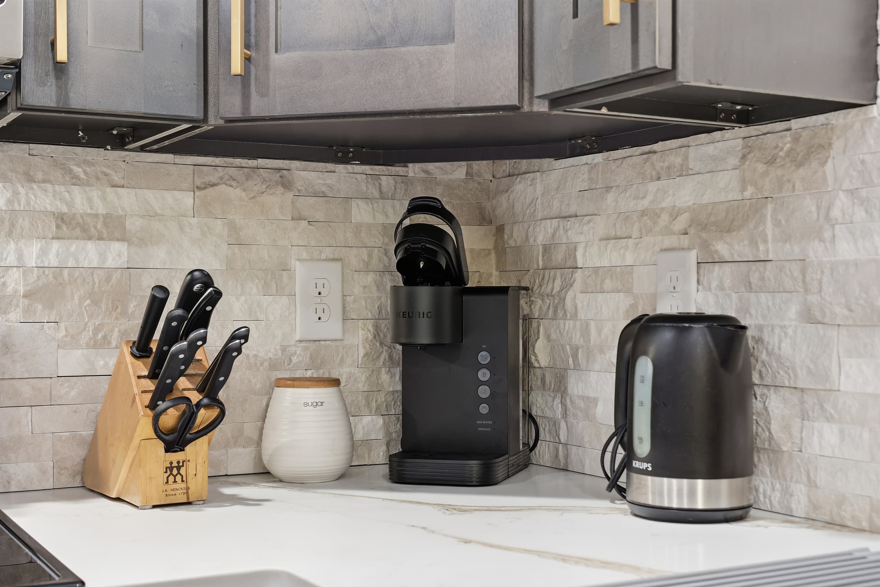 Fully stocked kitchen with stainless steel appliances, quartz countertop and a breakfast and dining area