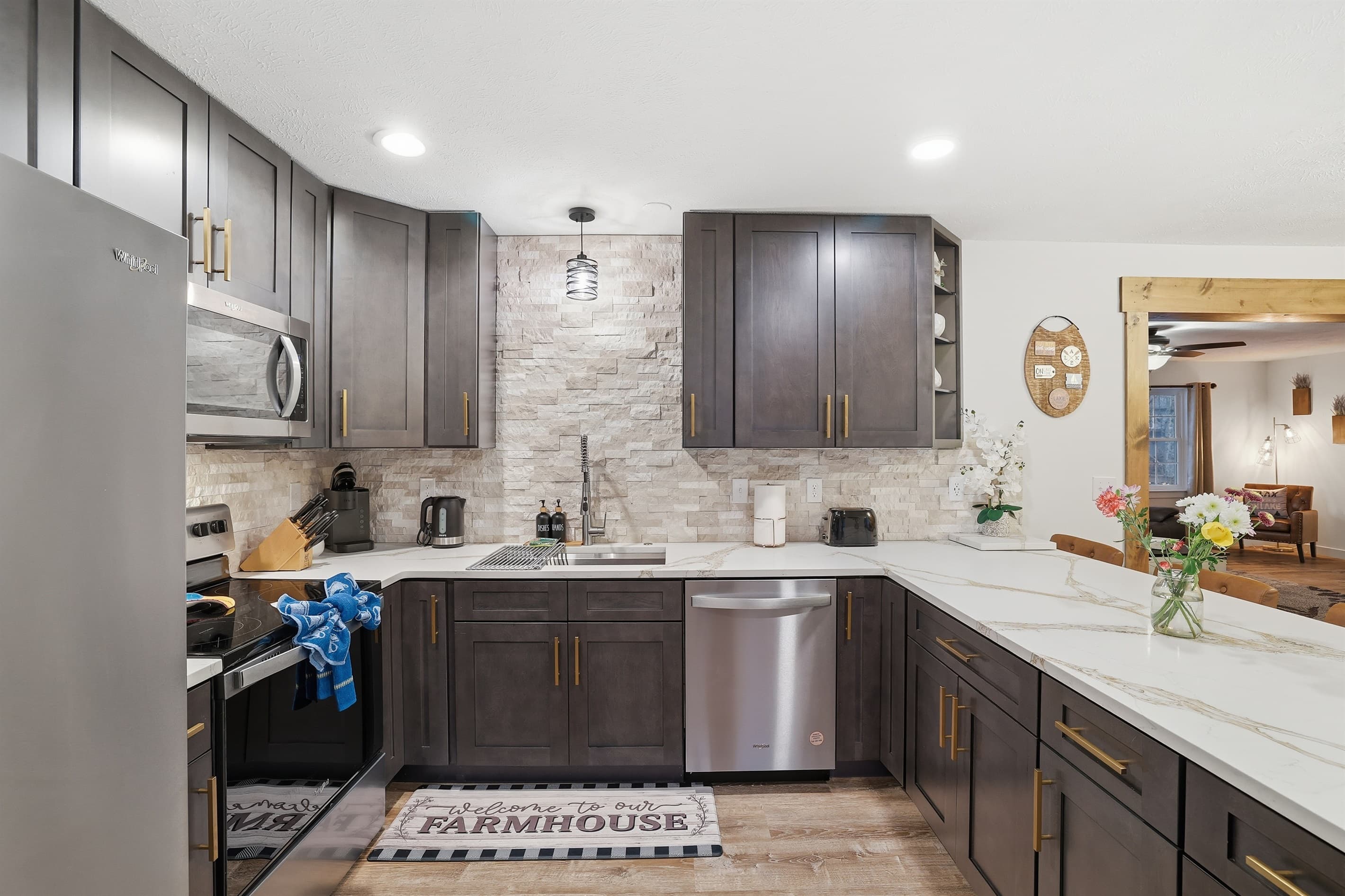 Fully stocked kitchen with stainless steel appliances, quartz countertop and a breakfast and dining area