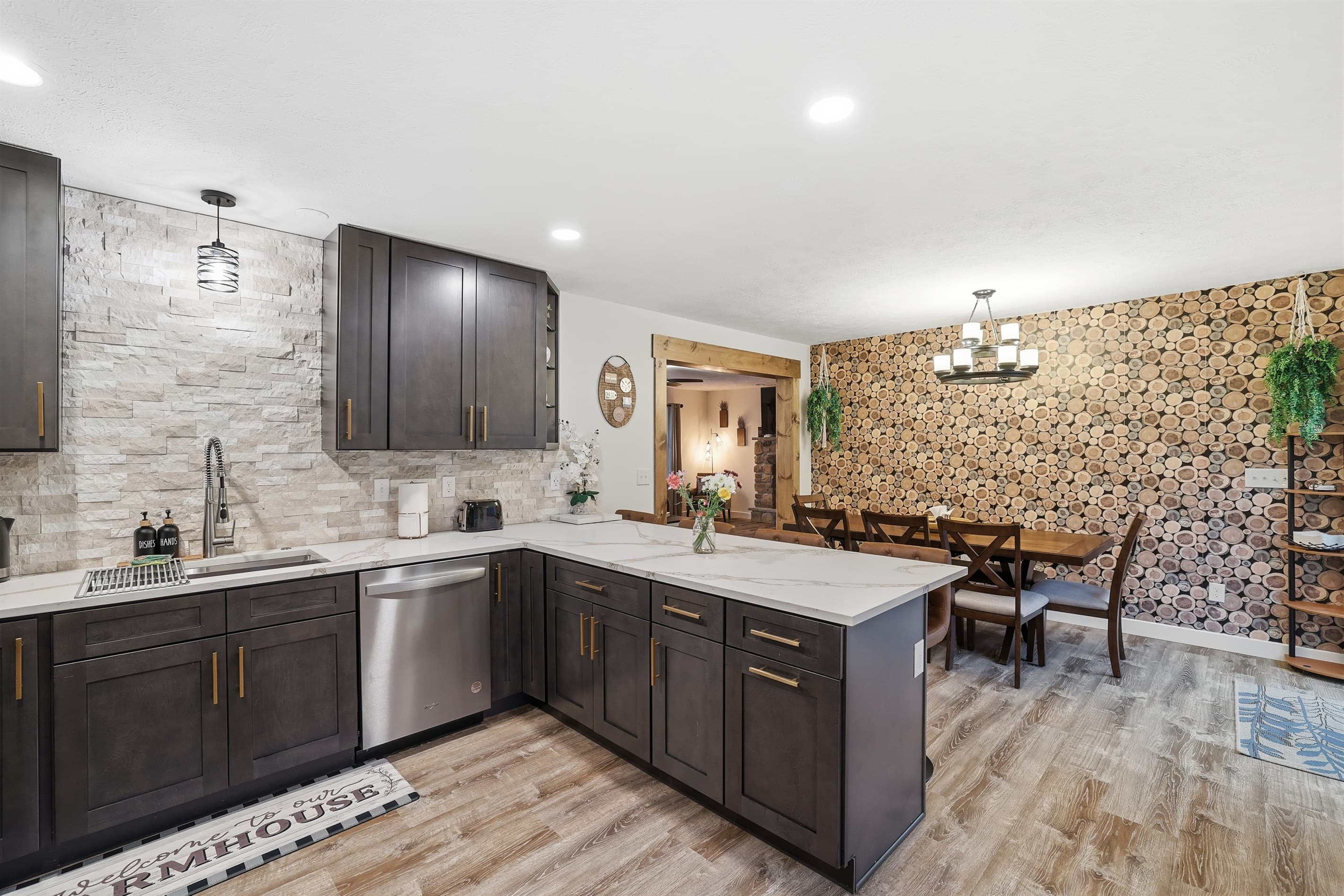 Fully stocked kitchen with stainless steel appliances, quartz countertop and a breakfast and dining area